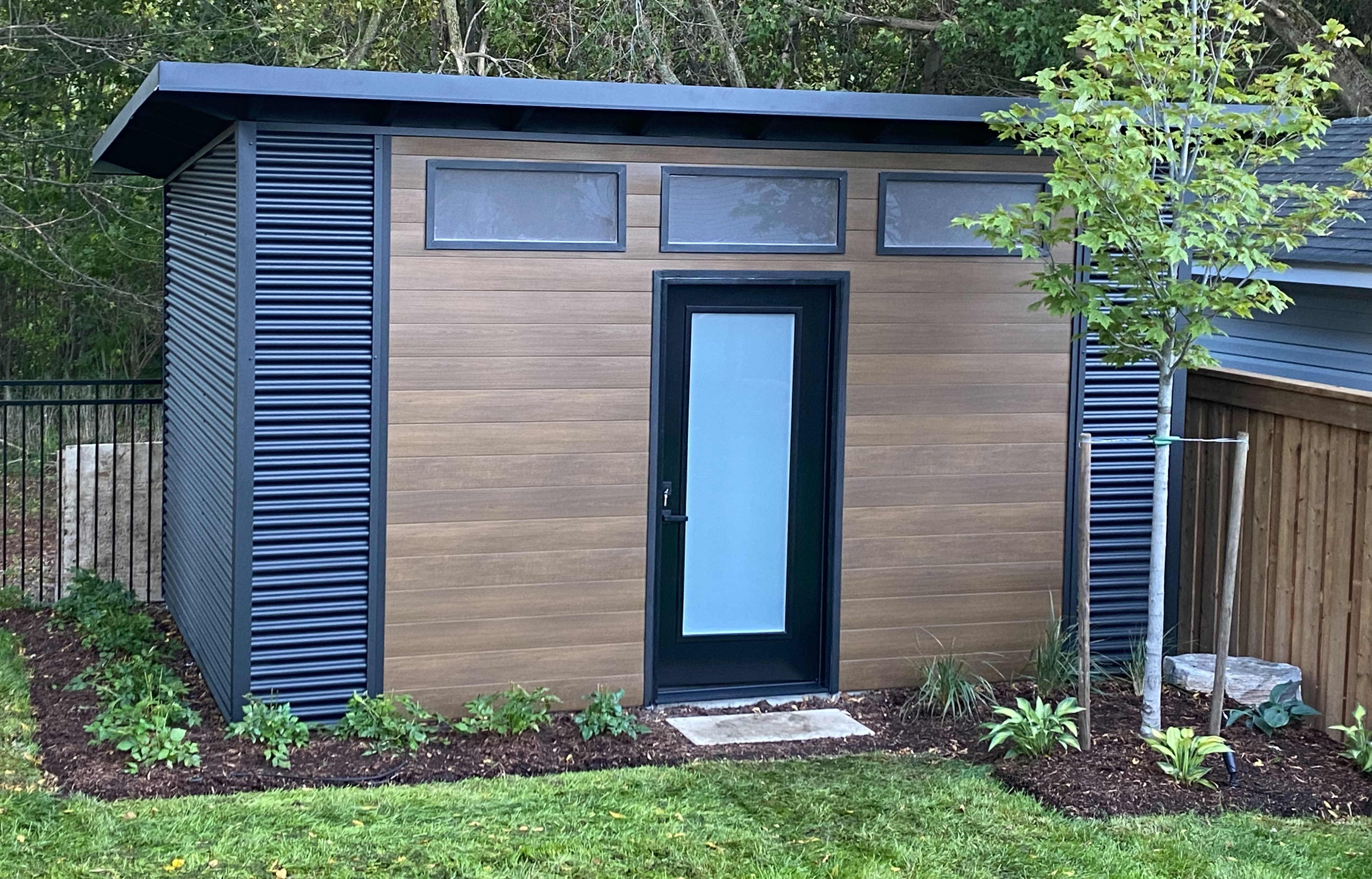 Backyard Escape shed exterior with Harrywood PLUS Teak composite siding