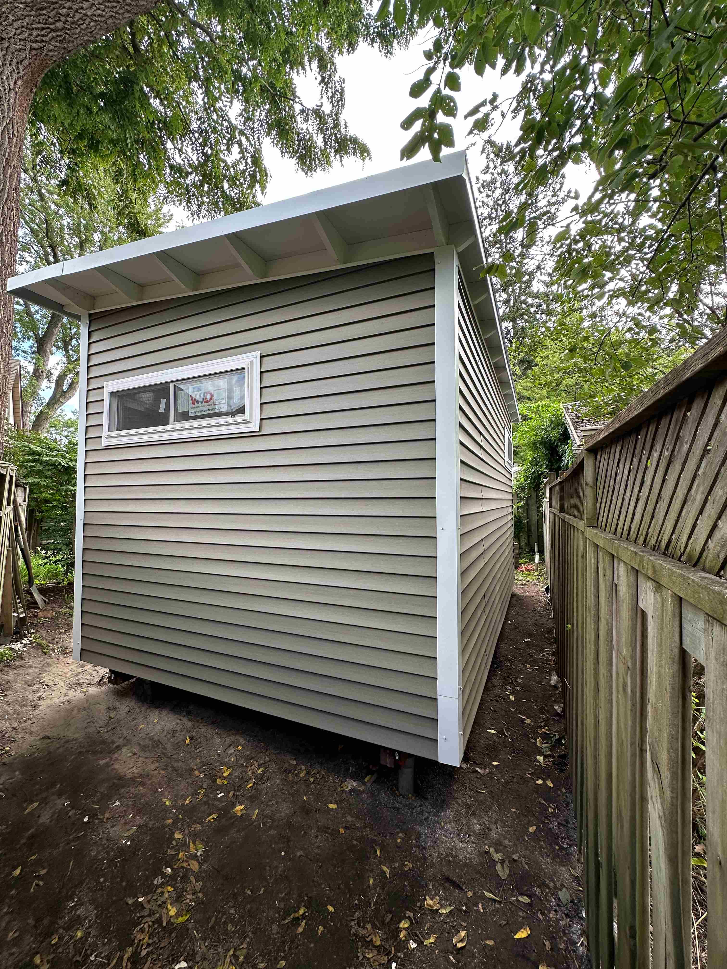 16x10 backyard studio back exterior with taupe vinyl siding in Scarborough Ontario