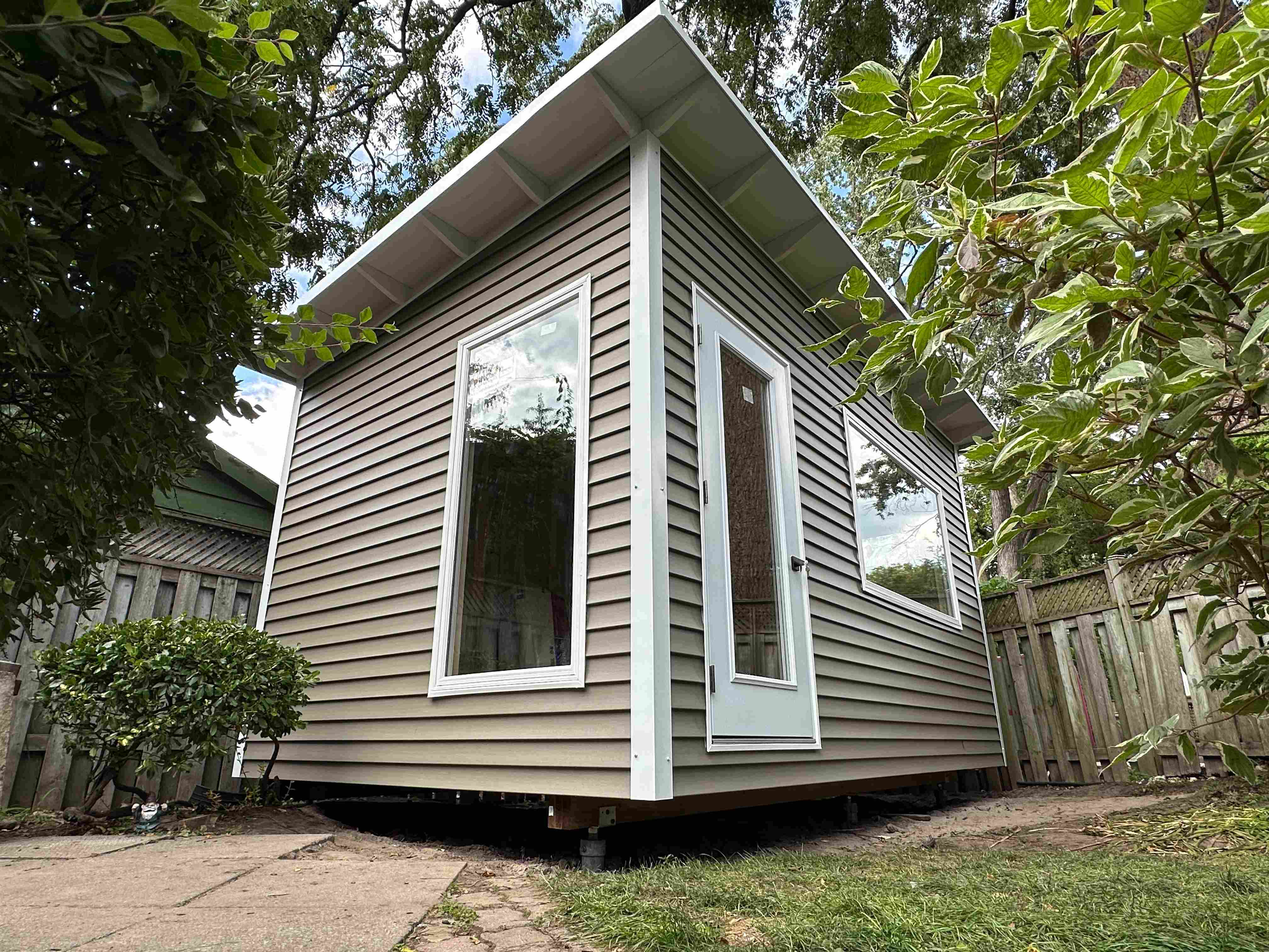 16x10 backyard studio corner view showing full-glass entry door and slim windows in Scarborough Ontario