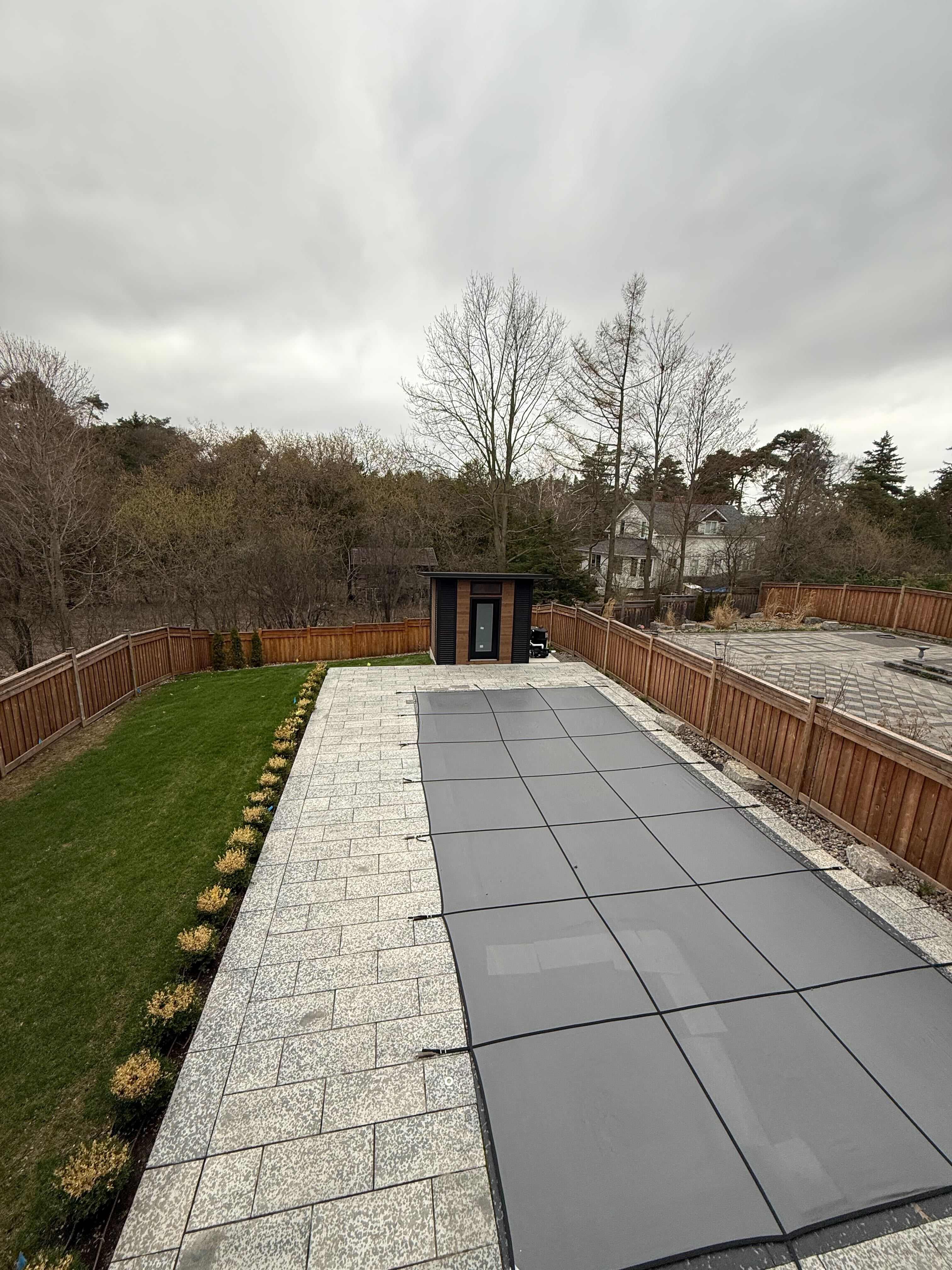 10x8 Advanced Shed with black corrugated steel siding and cedar-stained pine front wall with frosted glass door in Aurora Ontario