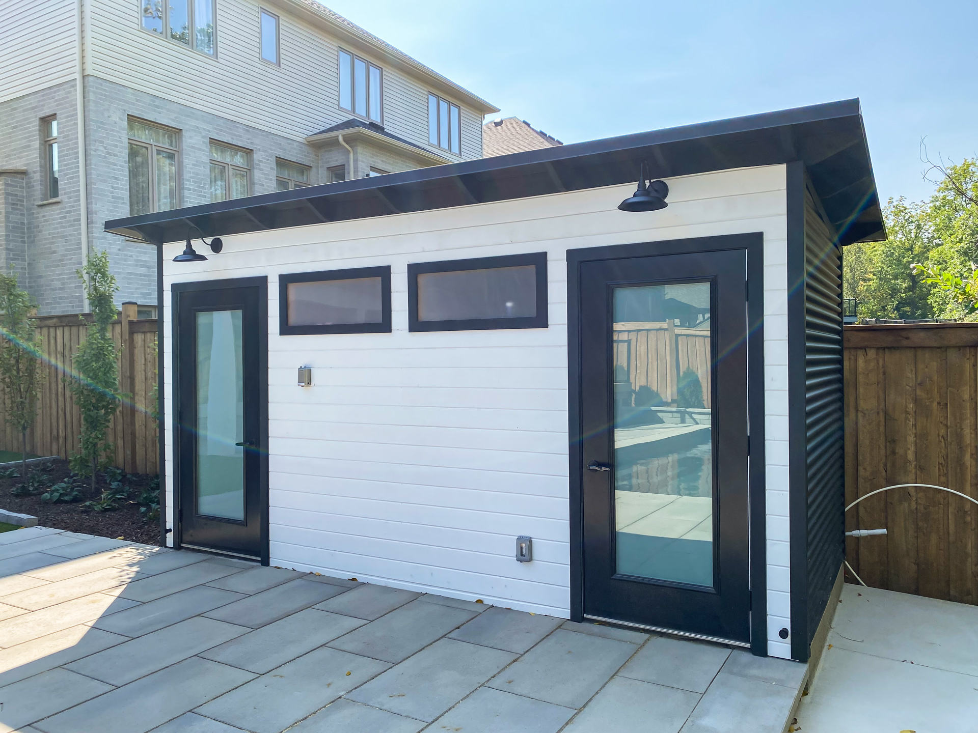 Modern backyard studio with cedar siding installed in a London, Ontario backyard