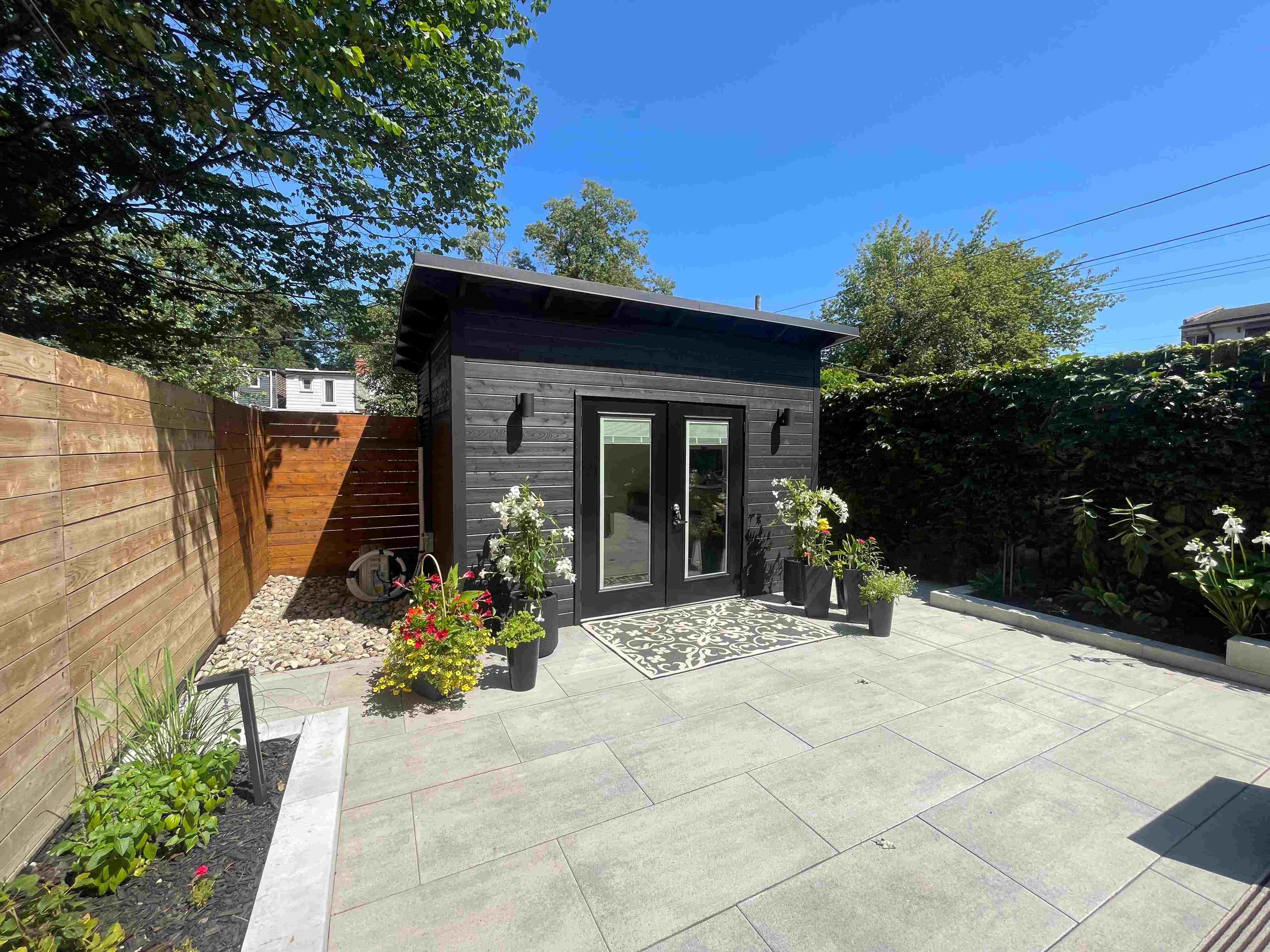 Modern backyard studio with cedar siding installed in a Markham Ontario backyard