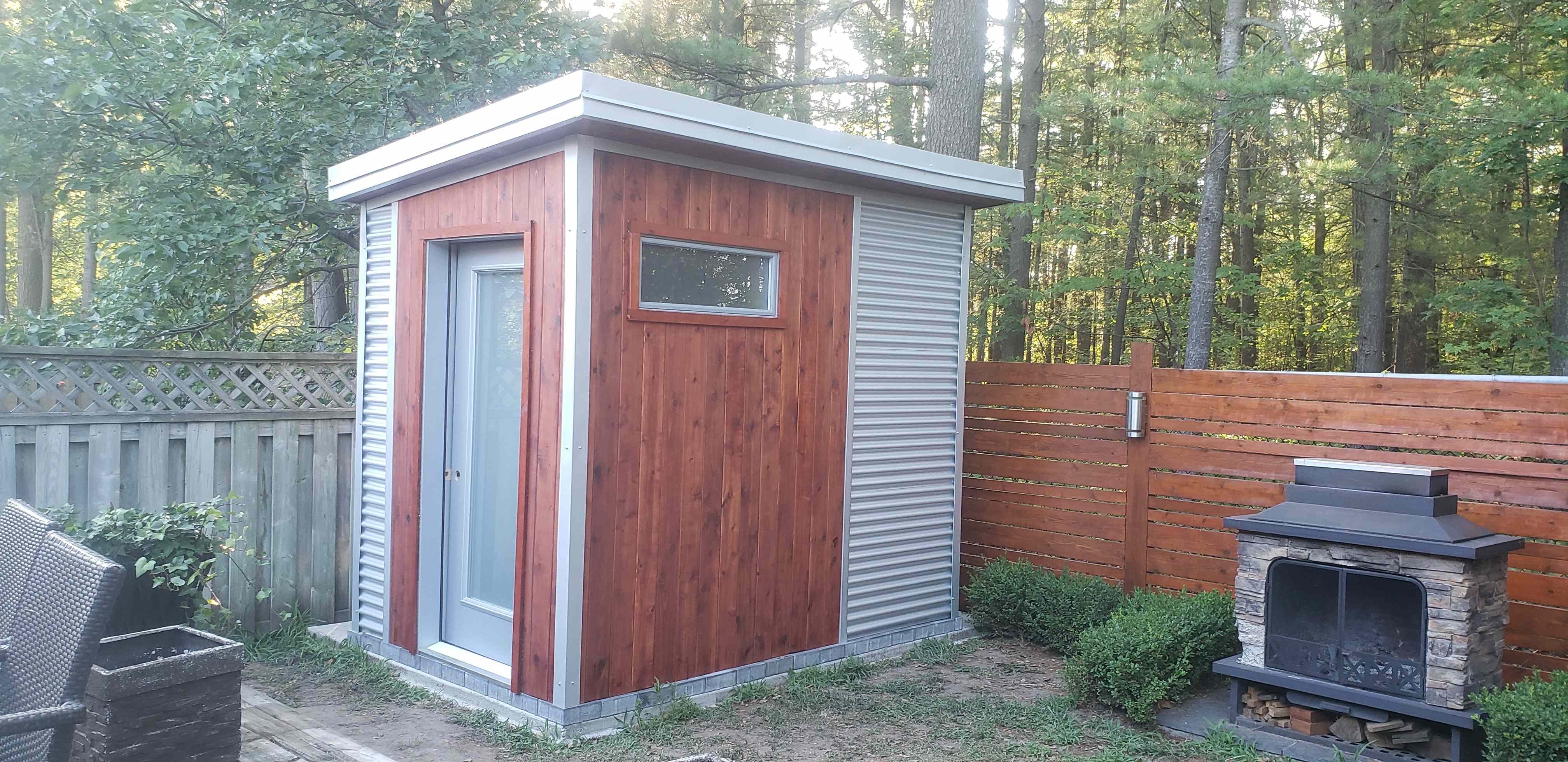 9x6 sauna shed with cedar front wall, Galvalume corrugated steel siding, and horizontal transom window in Barrie Ontario, installed by Backyard Escape Studios.