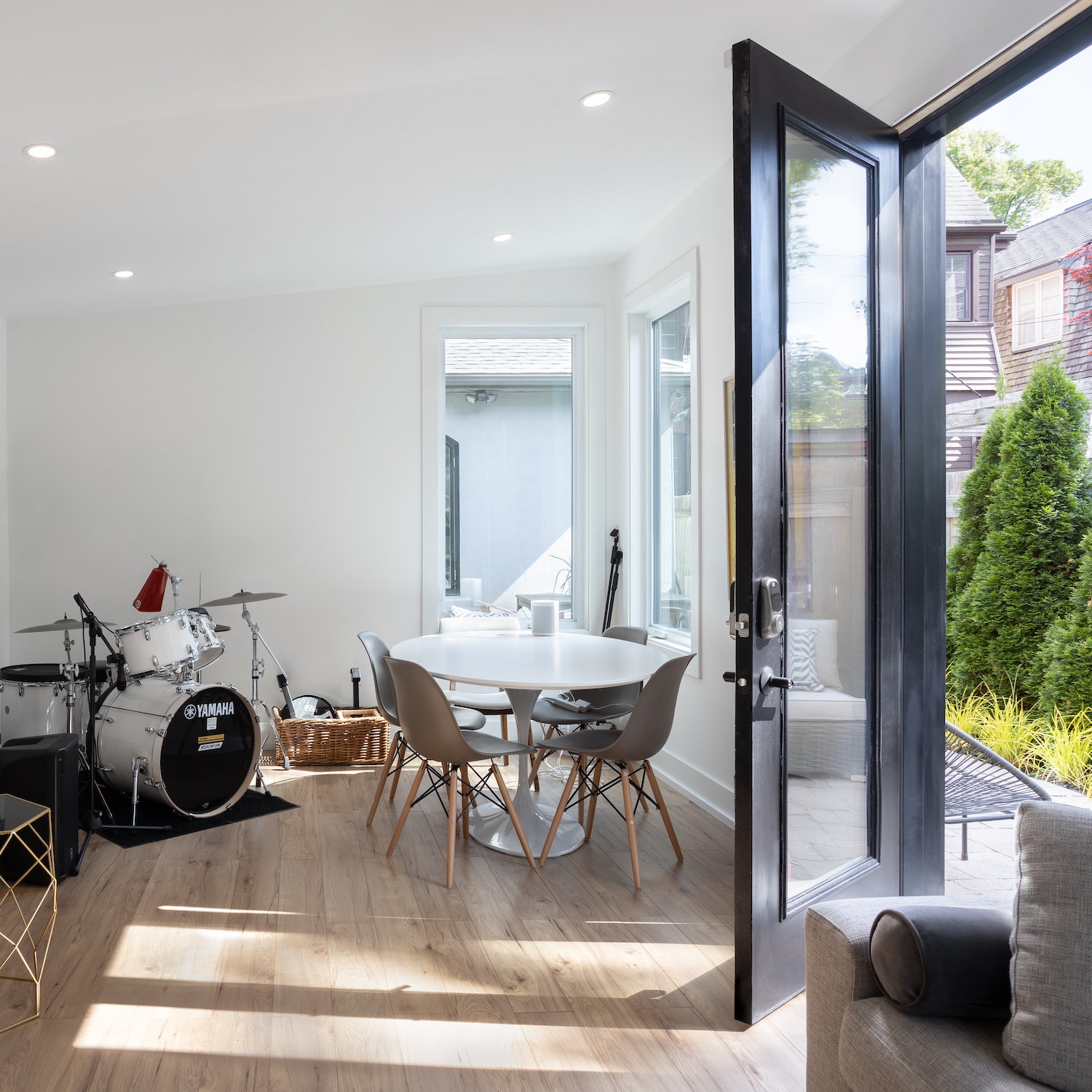 Backyard cedar studio interior set up as a private drum room with full insulation, climate control, and aluminum windows