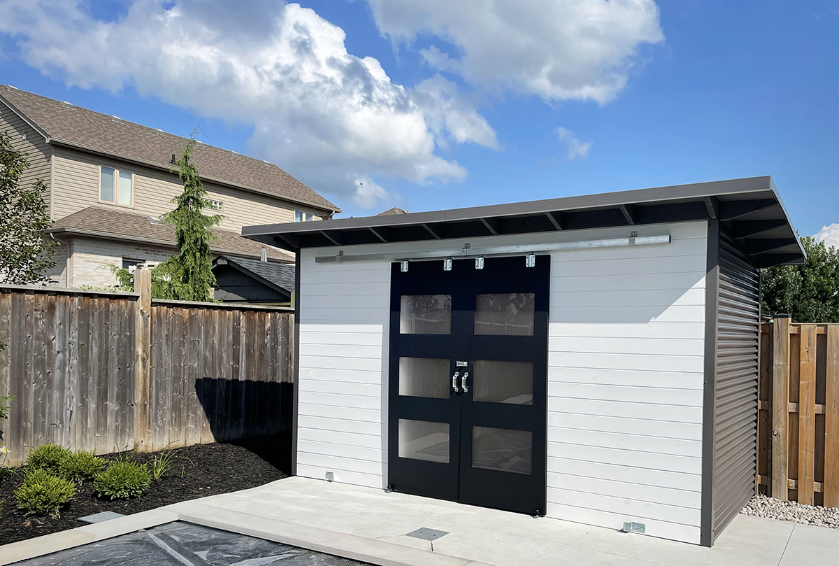 14x6.5 Pool Shed installed on a concrete pad beside a backyard pool in Komoka Ontario by Backyard Escape Studios.