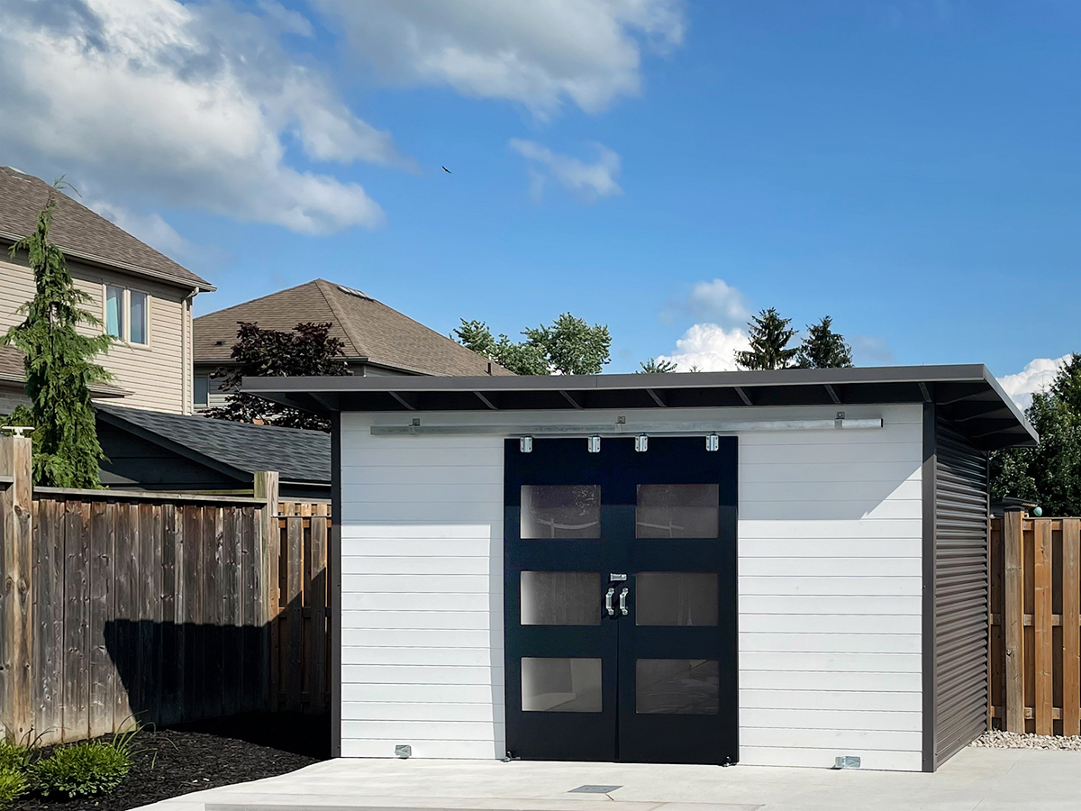 14x6.5 Pool Shed Essential Shed with Charcoal corrugated steel siding, white pine front, and double sliding barn doors in Komoka Ontario installed by Backyard Escape Studios.