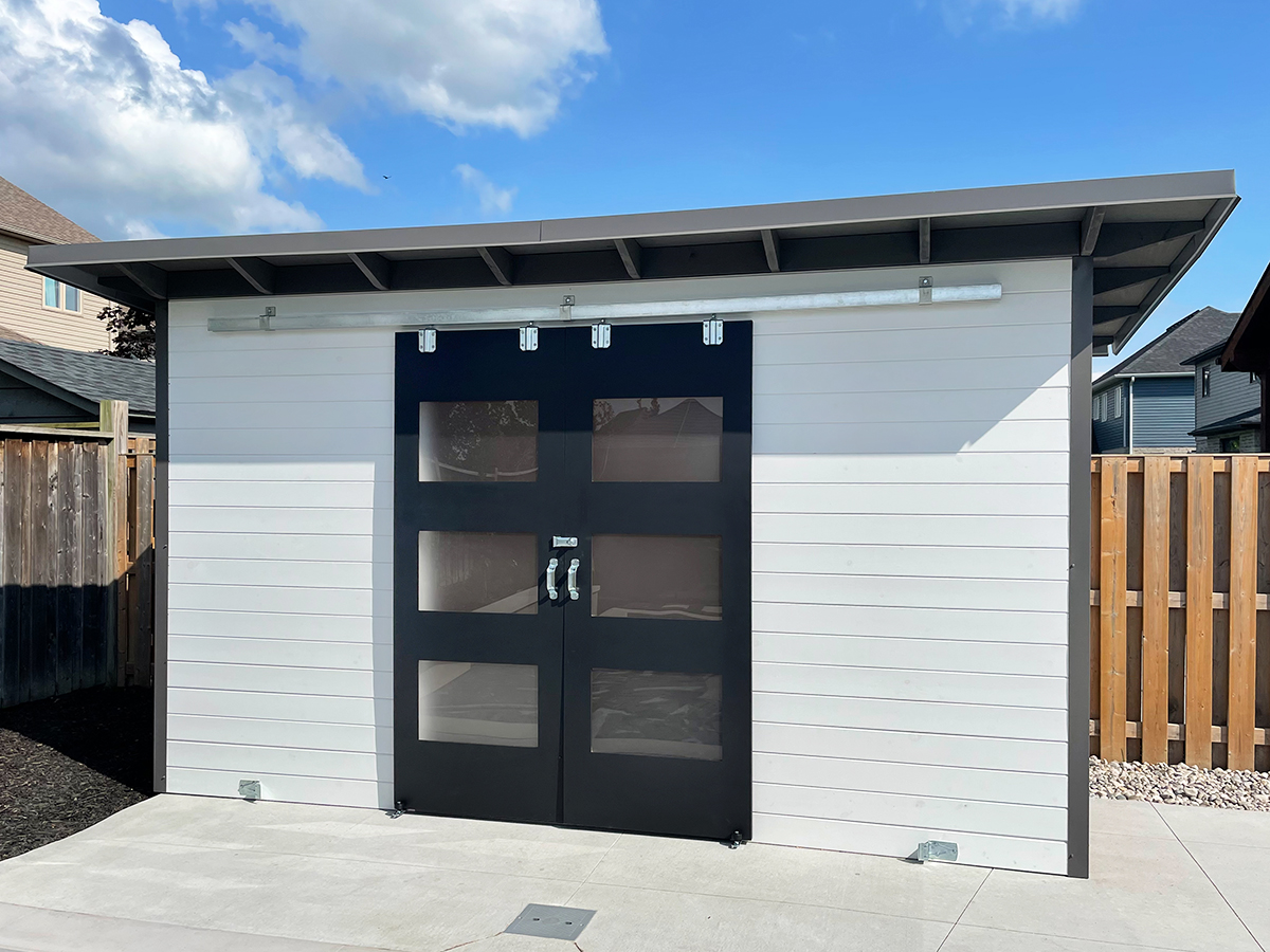 14x6.5 Pool Shed double sliding barn doors with frosted Lexan windows and galvanized track in Komoka Ontario installed by Backyard Escape Studios.