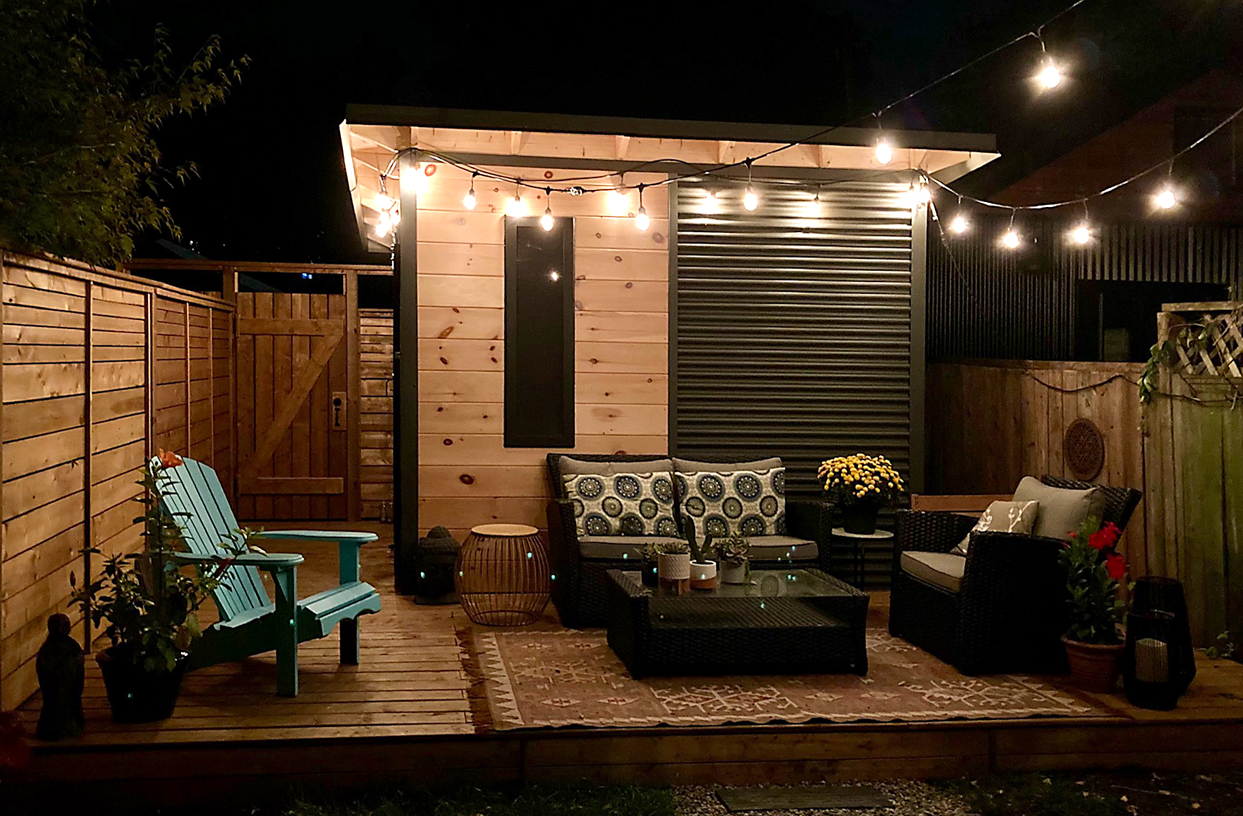 10x10 Garden Shed in Toronto Ontario at night with a frosted Lexan window glowing on the pine front wall installed by Backyard Escape Studios.
