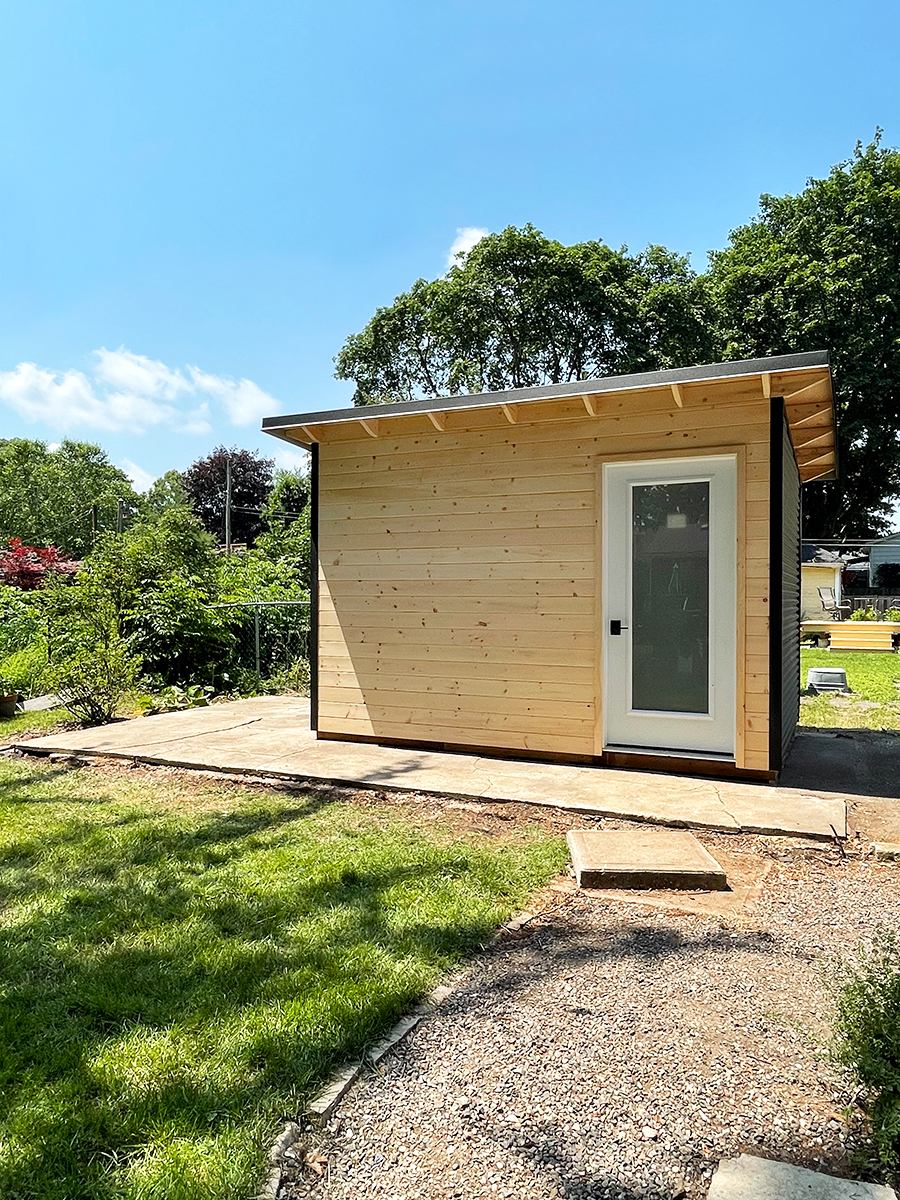 12x8 Garden Shed installed in a Stratford, Ontario backyard with gravel pathway and lawn.