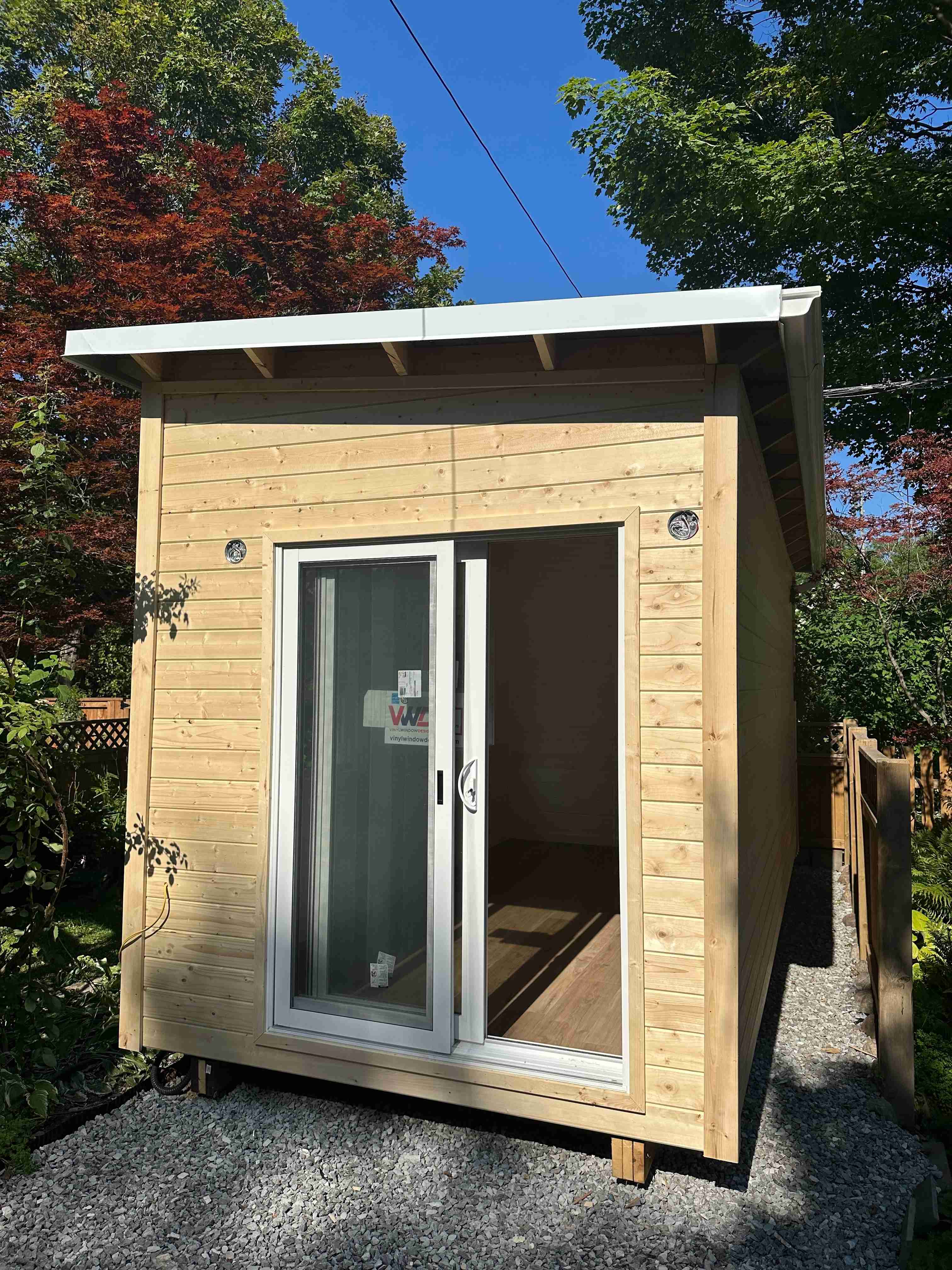 20x8 Backyard Office studio exterior with pine tongue-and-groove siding and open sliding glass door in Toronto, Ontario