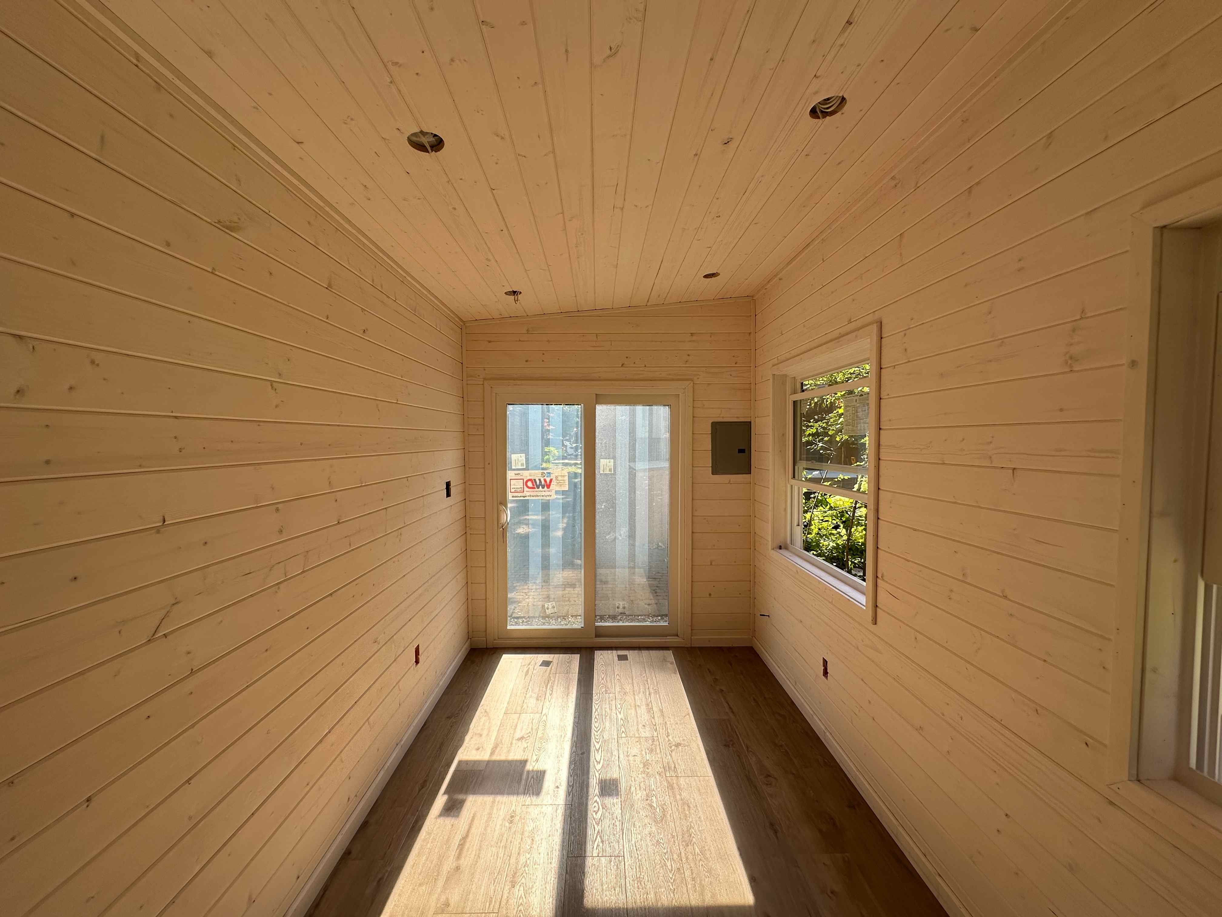 Finished pine tongue-and-groove interior walls and ceiling inside a 20x8 Backyard Office studio in Toronto, Ontario
