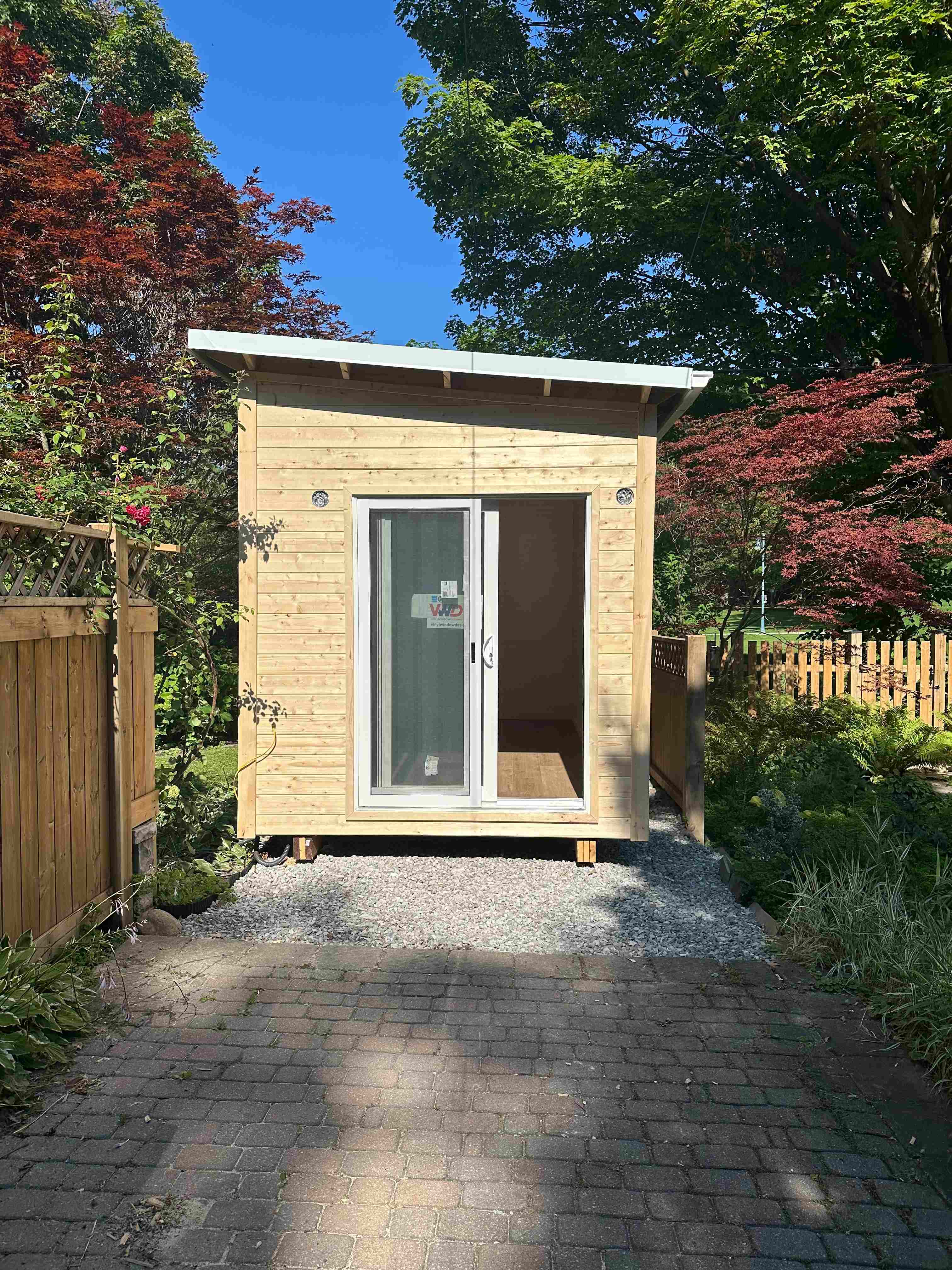 hite sliding glass patio door on a 20x8 Backyard Office studio with natural pine siding in Toronto, Ontario