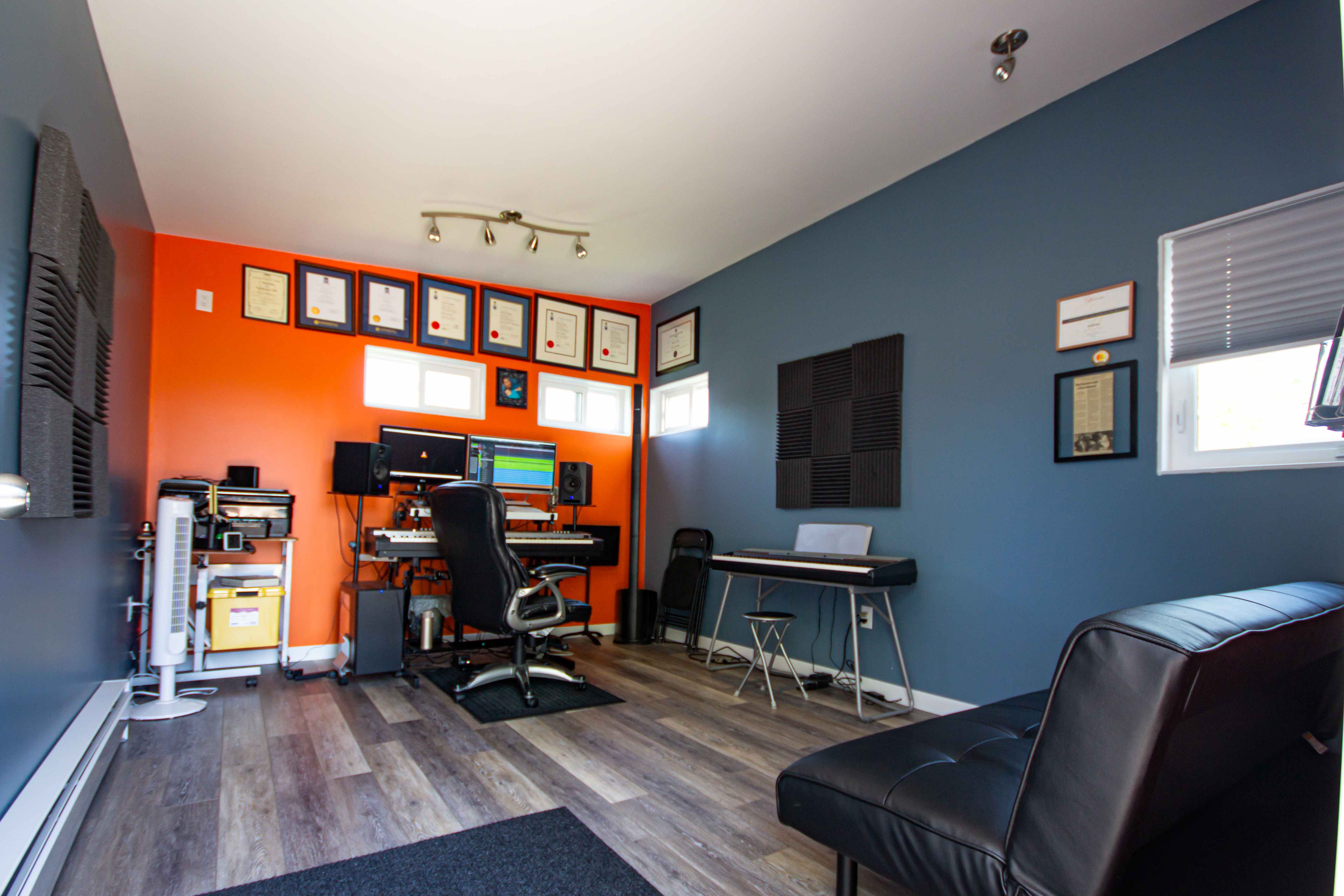 16x12 Music Studio with slate blue vertical steel siding and a natural wood soffit accent in Windsor, Ontario, installed by Backyard Escape Studios.