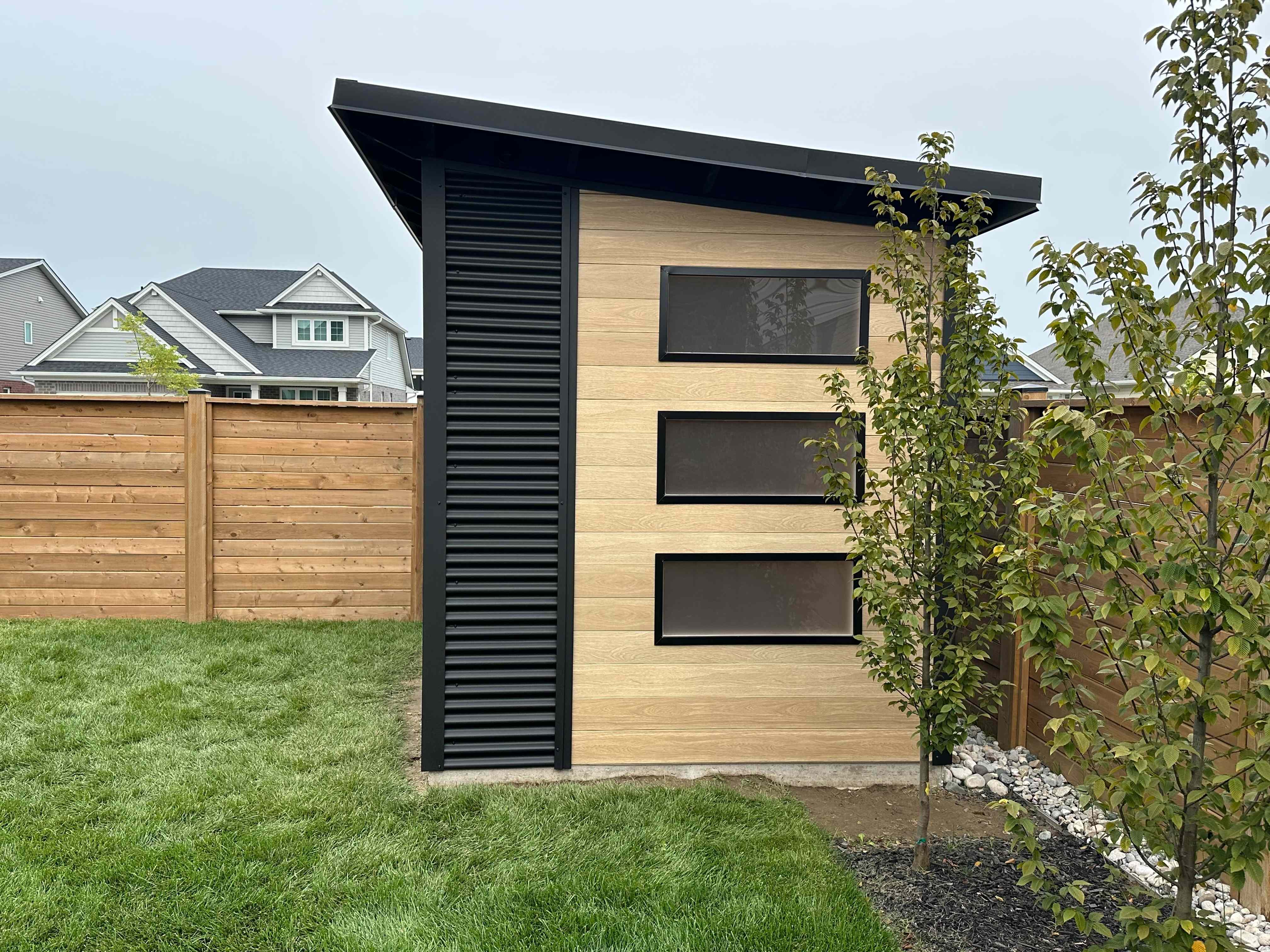 Side profile of an 11x8 Modern Shed showing black steel and Cork siding in St. Thomas Ontario