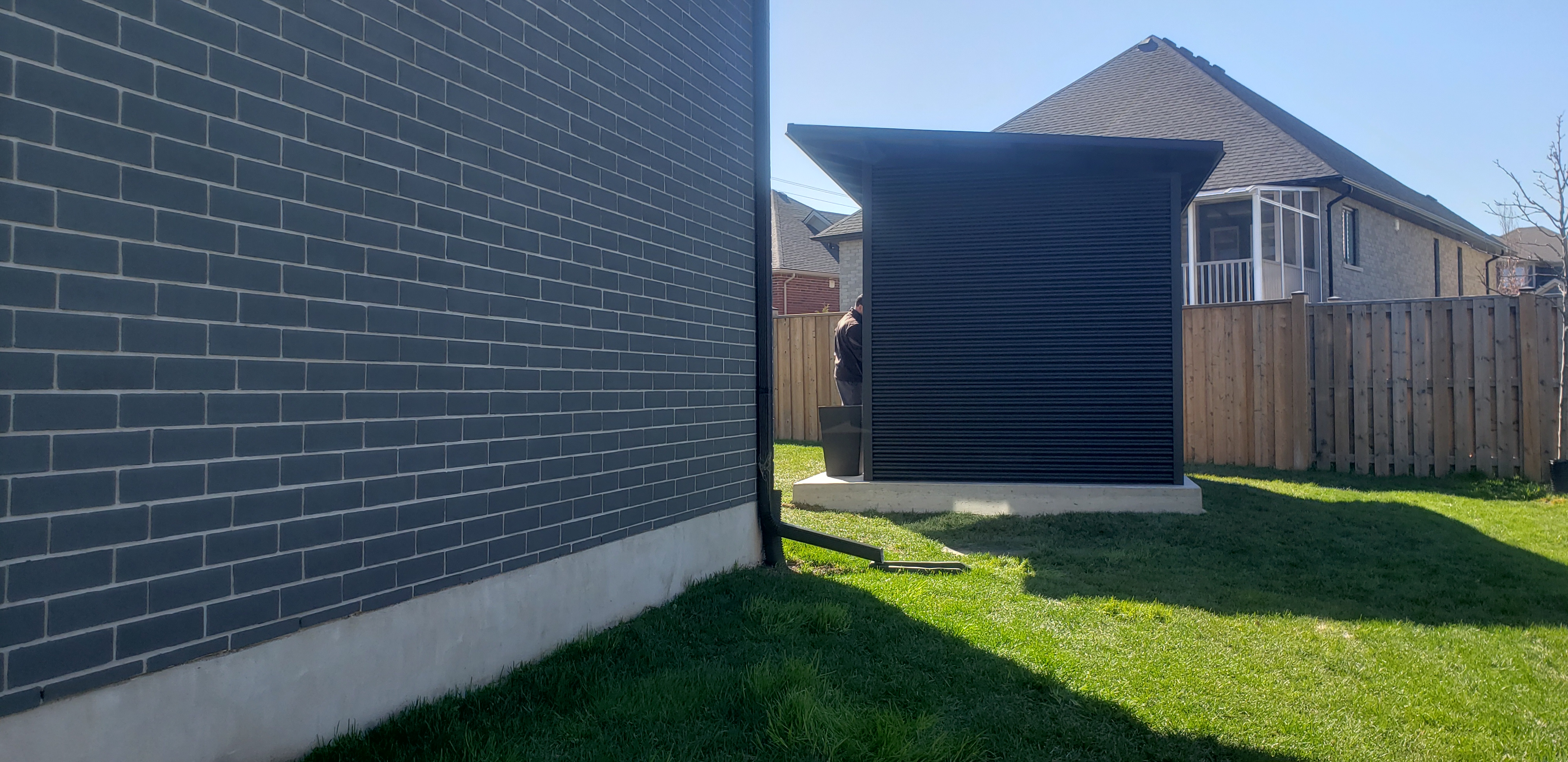 Side view of 12x8 Modern Shed with Jet Black corrugated steel siding during installation near London, Ontario