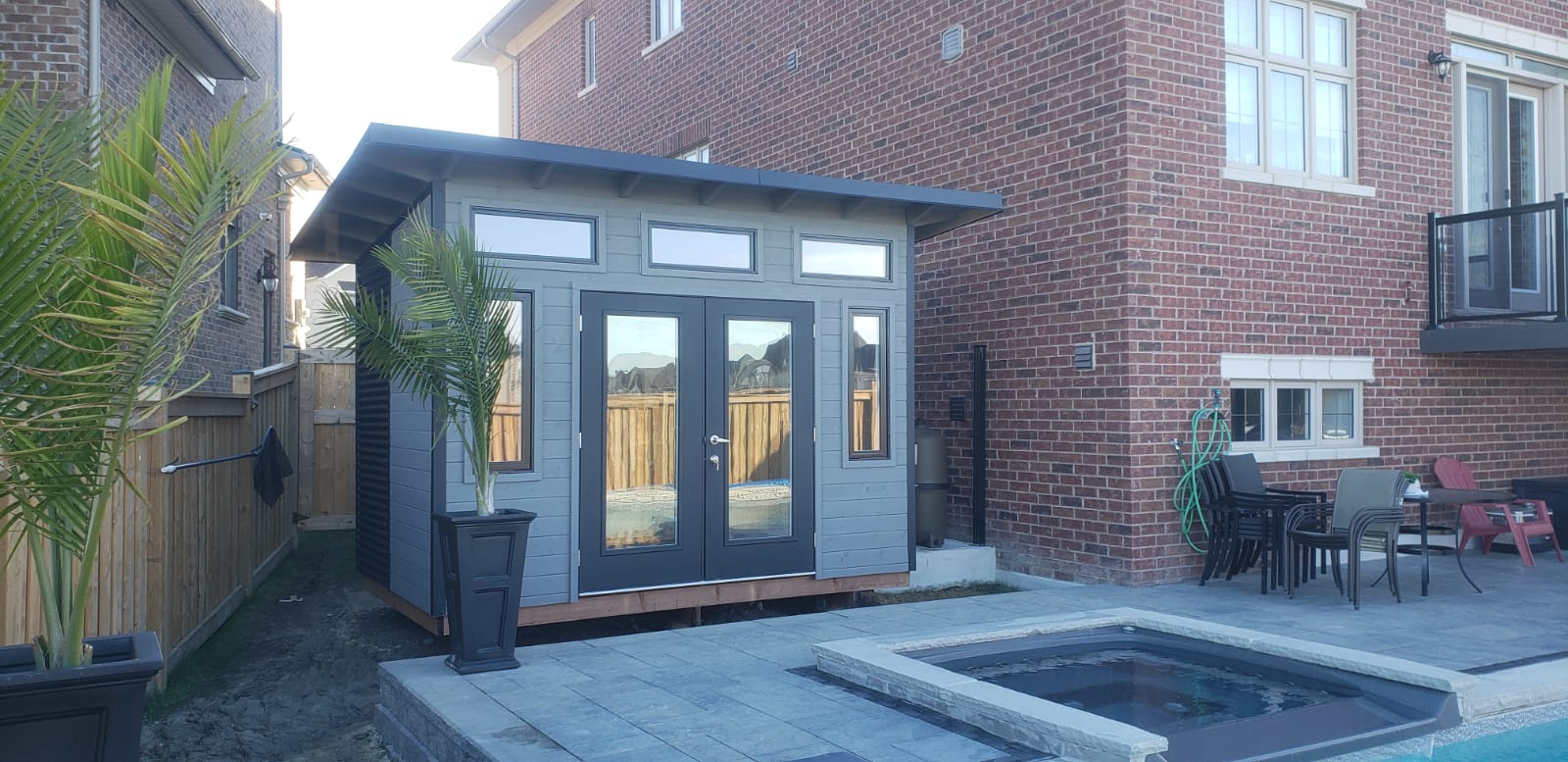 12x8 Advanced Shed pool shed with black steel siding and charcoal pine panelling in King City, Ontario, installed by Backyard Escape Studios