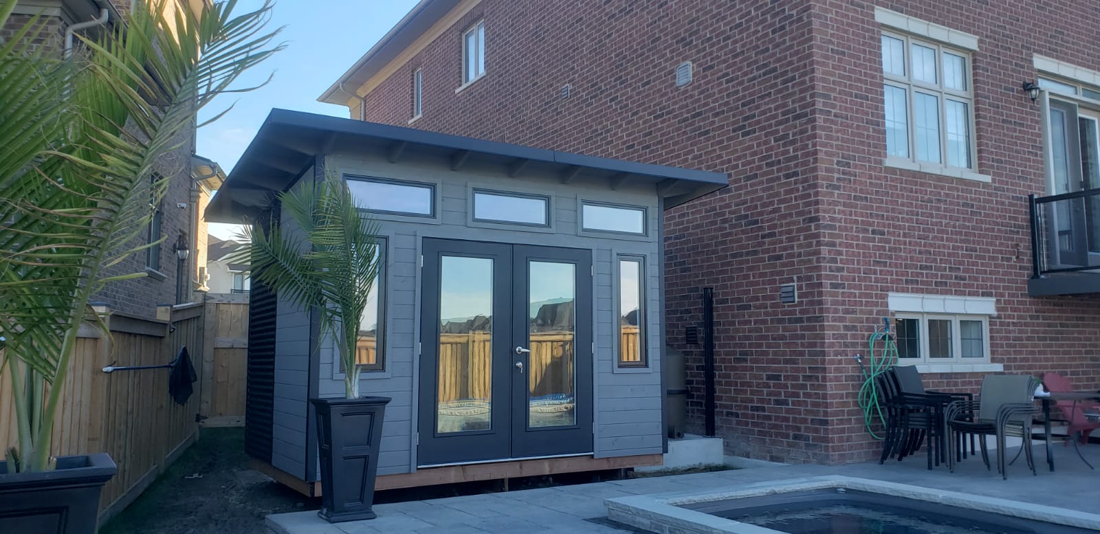 Modern 12x8 pool shed with black-trim casement windows and a sloped roof in King City Ontario