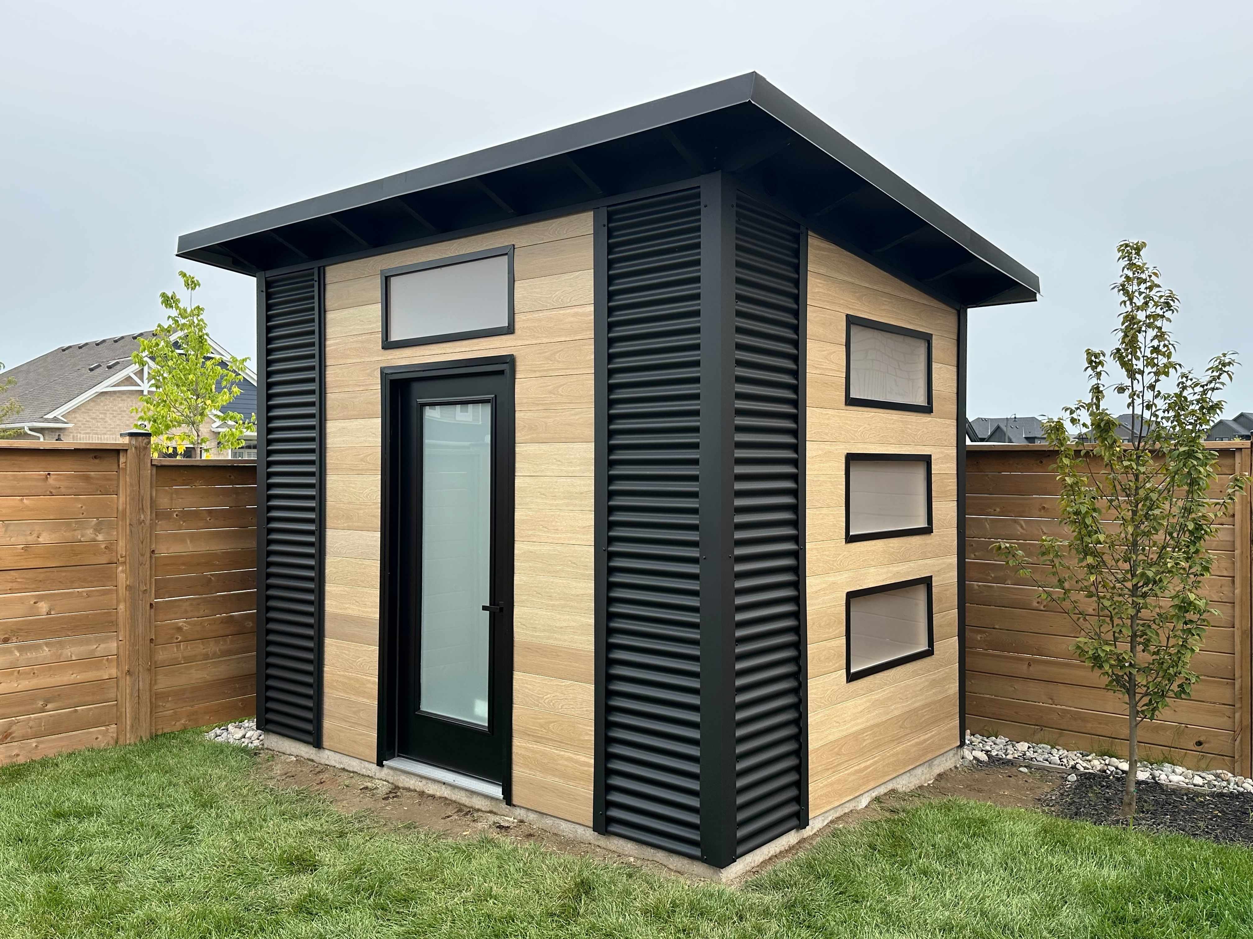 Backyard studio with cedar siding installed in a St. Thomas Ontario backyard