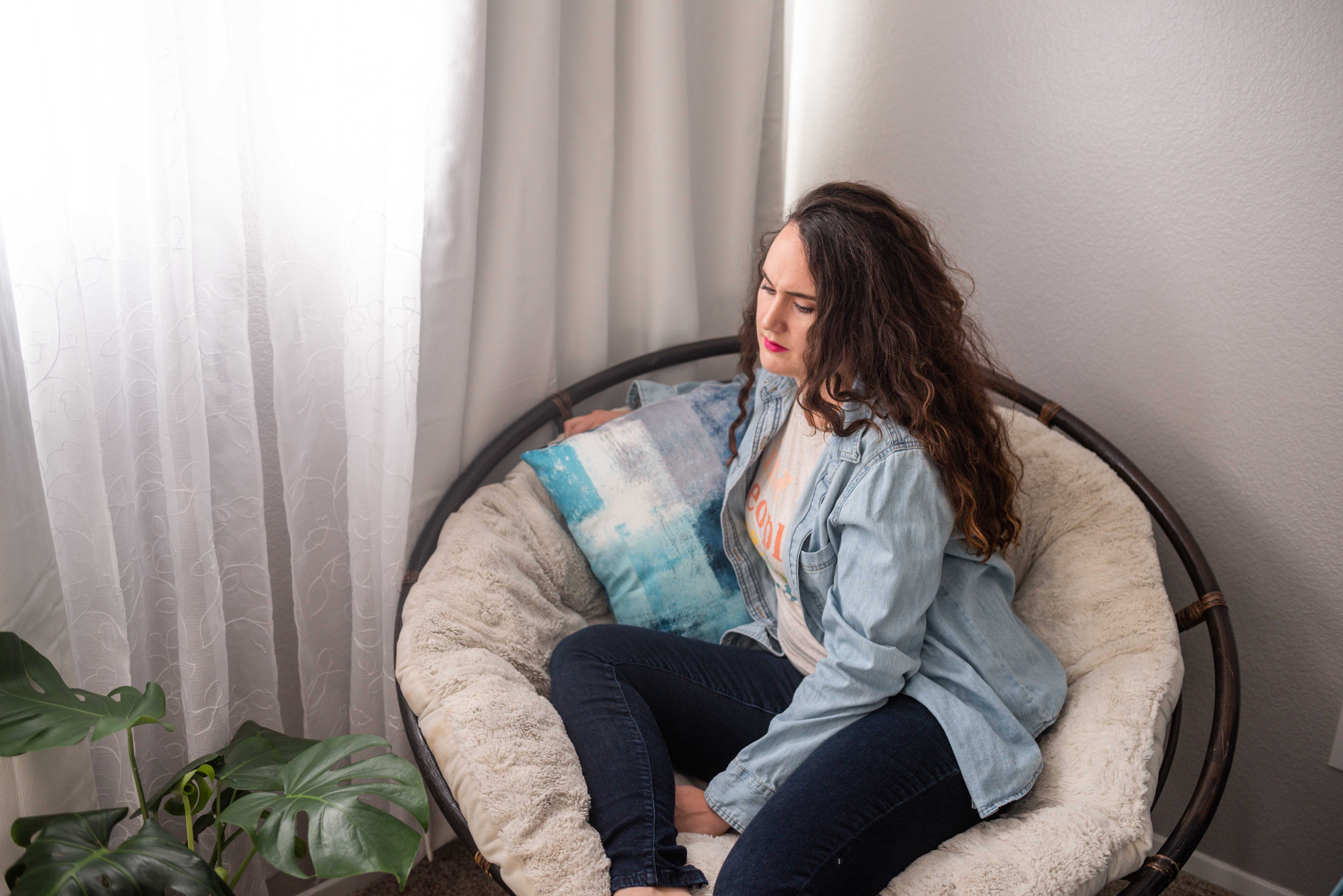 a woman sitting in a round chair