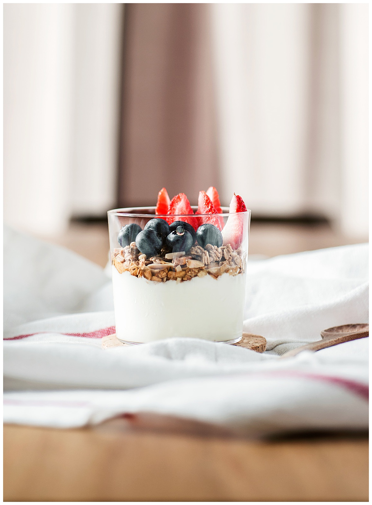 a glass of yogurt with fruit in it