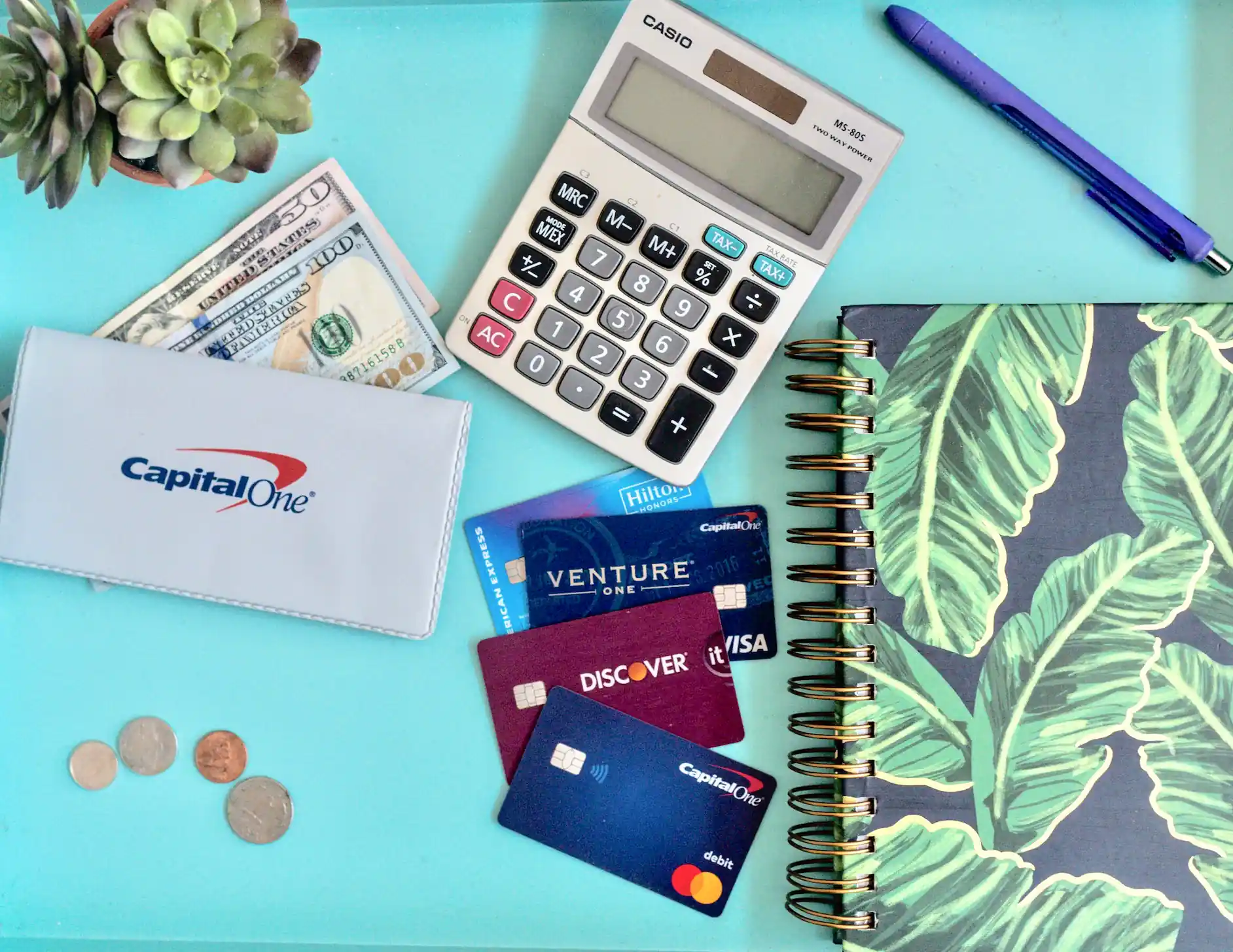 a calculator and credit cards on a blue surface