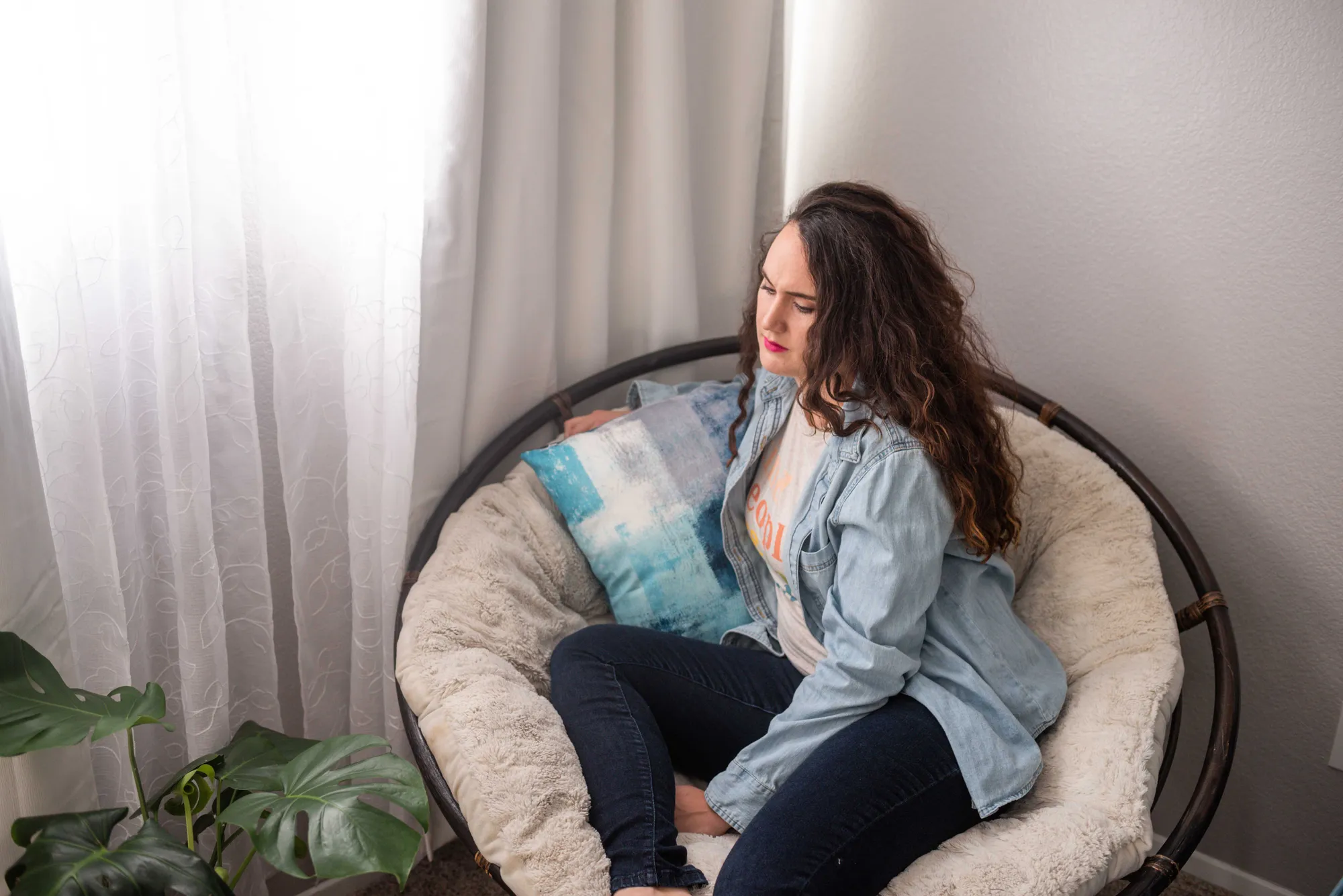a woman sitting in a round chair