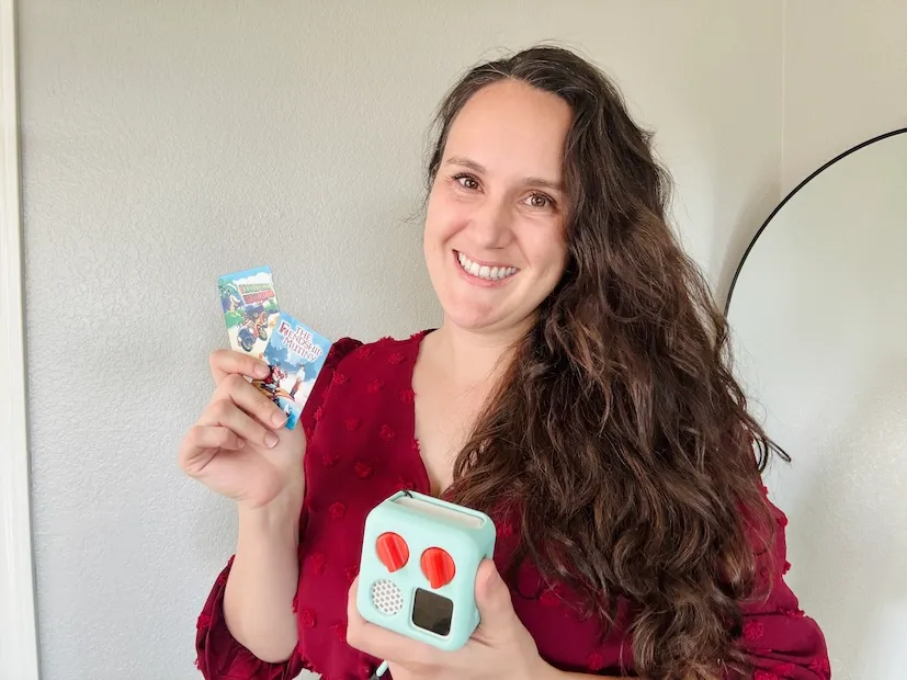 Smiling mom holding a homemade Yoto card and a Yoto player