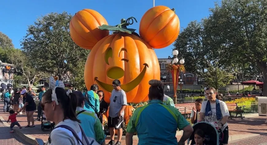 Giant Mickey Mouse pumpkin at Disneyland with families walking by