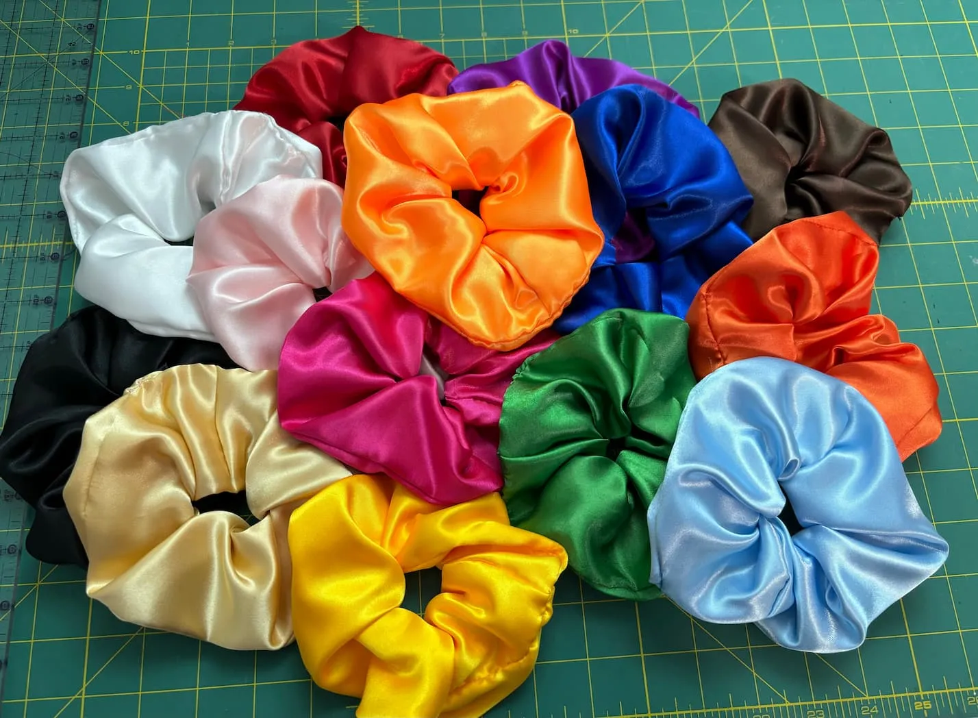a group of colorful scrunchies on a green mat