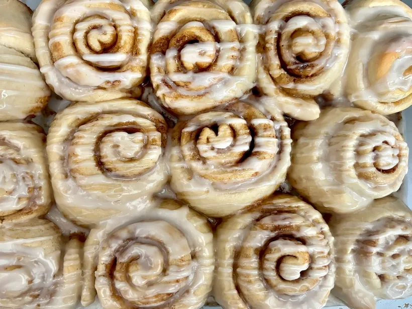 Pan of iced vegan cinnamon rolls