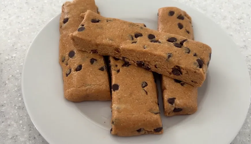 Peanut butter protein bars with chocolate chips on a white plate
