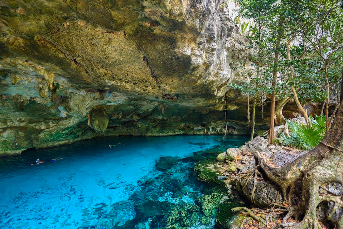 Entrance to crystal-clear water at Dos Ojos - one of the cenotes in Tulum