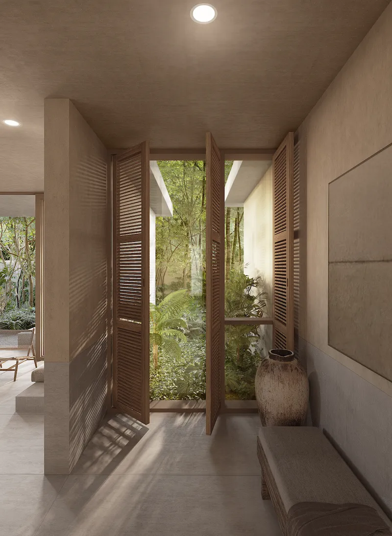 As you enter the condo, wooden blinds cast shade and frame the garden view - natural design typical of condos in Tulum