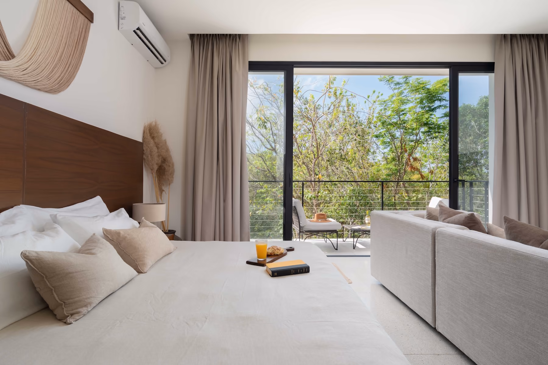 Furnished studio apartment with an open-plan living area and kitchen at 525 Tulum, a completed real estate development in Tulum.
