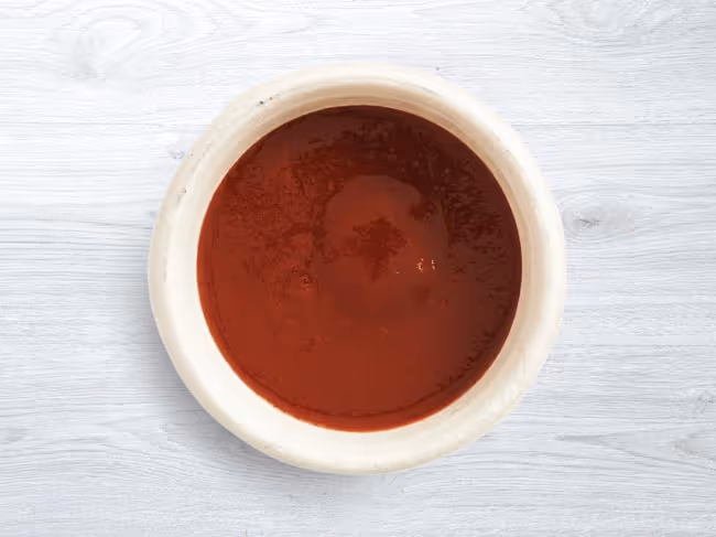 GYG hot sauce side in a dish