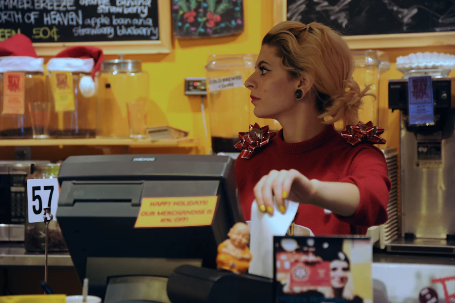 Store worker at a festive, decorated till during the holiday rush