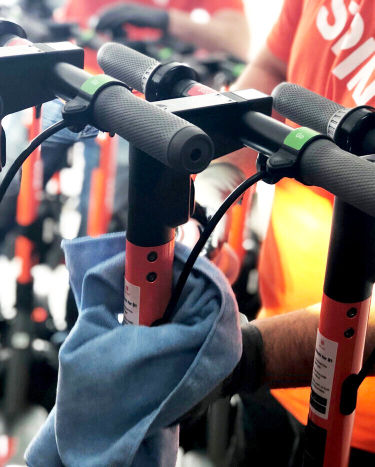 Spin+Employees+Disinfecting+Scooters.jpg