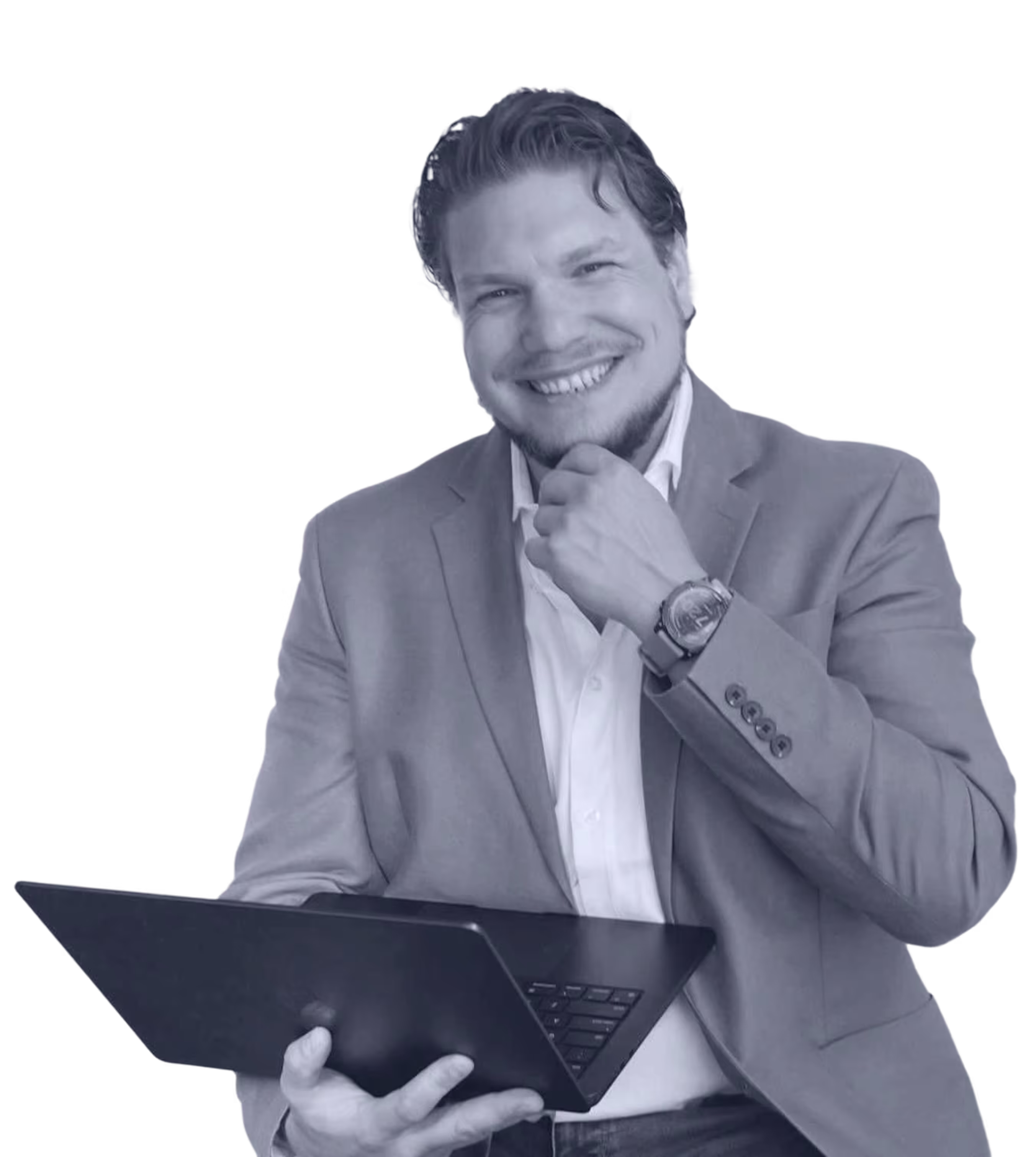 Anton is wearing a jacket and a white shirt, smiling and holding a laptop.