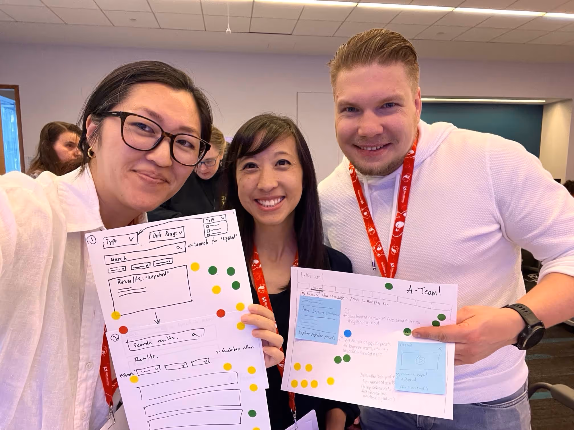 Anton, with his 2 peers, are happily demonstrating the results of the workshop. Everyone is smiling.