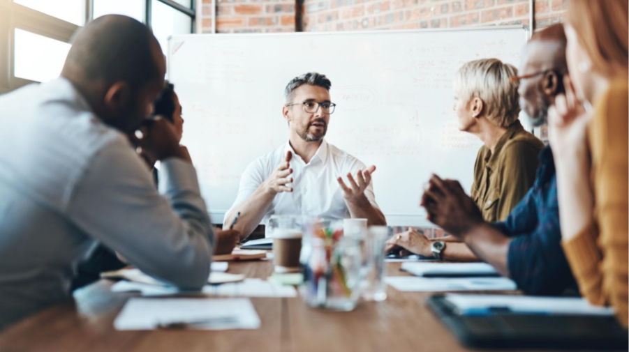 A group of people sitting around a tableAI-generated content may be incorrect.