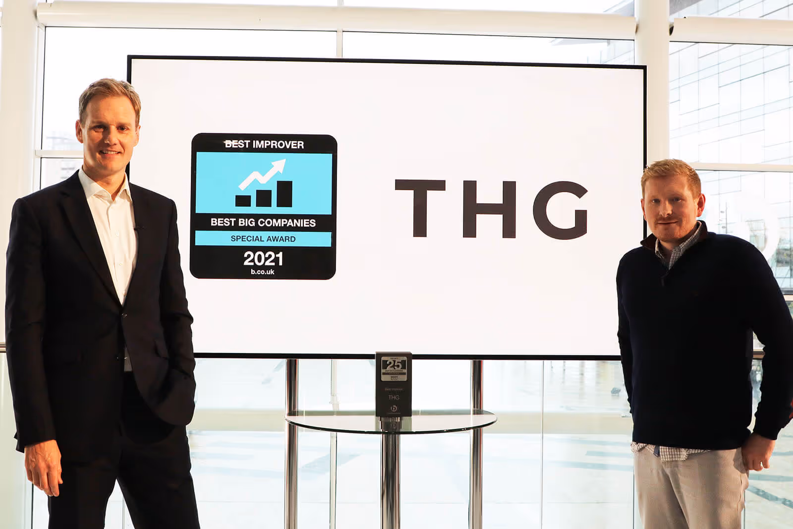 TV Presenter Dan Walker with The Hut Groups Group People Director Richard Nolan as he recieves the Best Improver Special Award at Best Companies Live