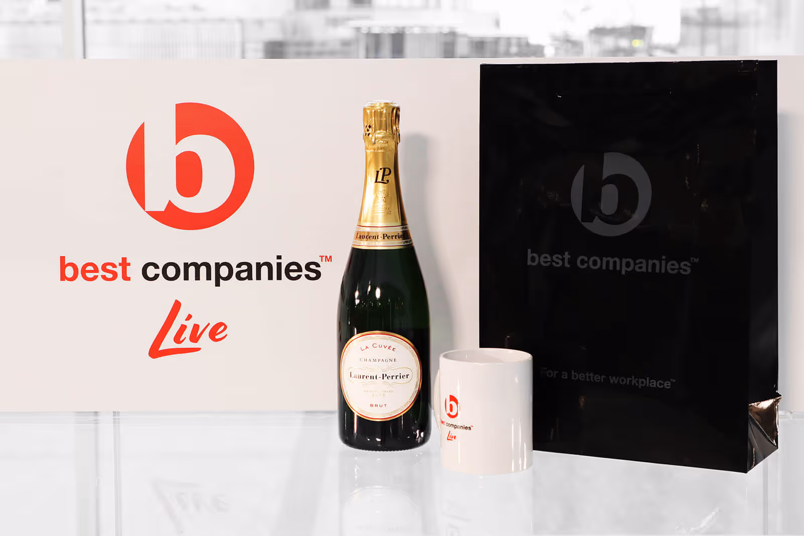 Best Companies Live Logo with Laurent Perrier Champagne and the official Best Companies Live mug