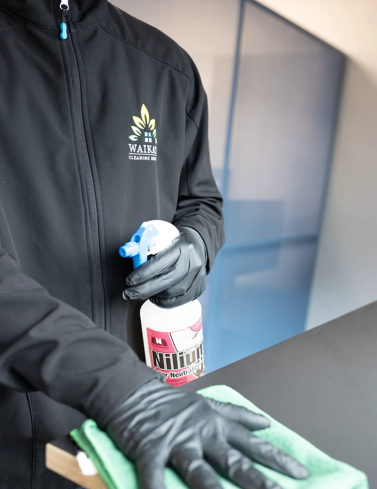 Cleaner wiping an accessible hospitality surface