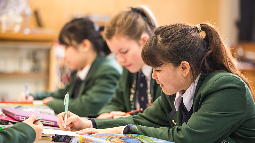 School students working at classroom desks