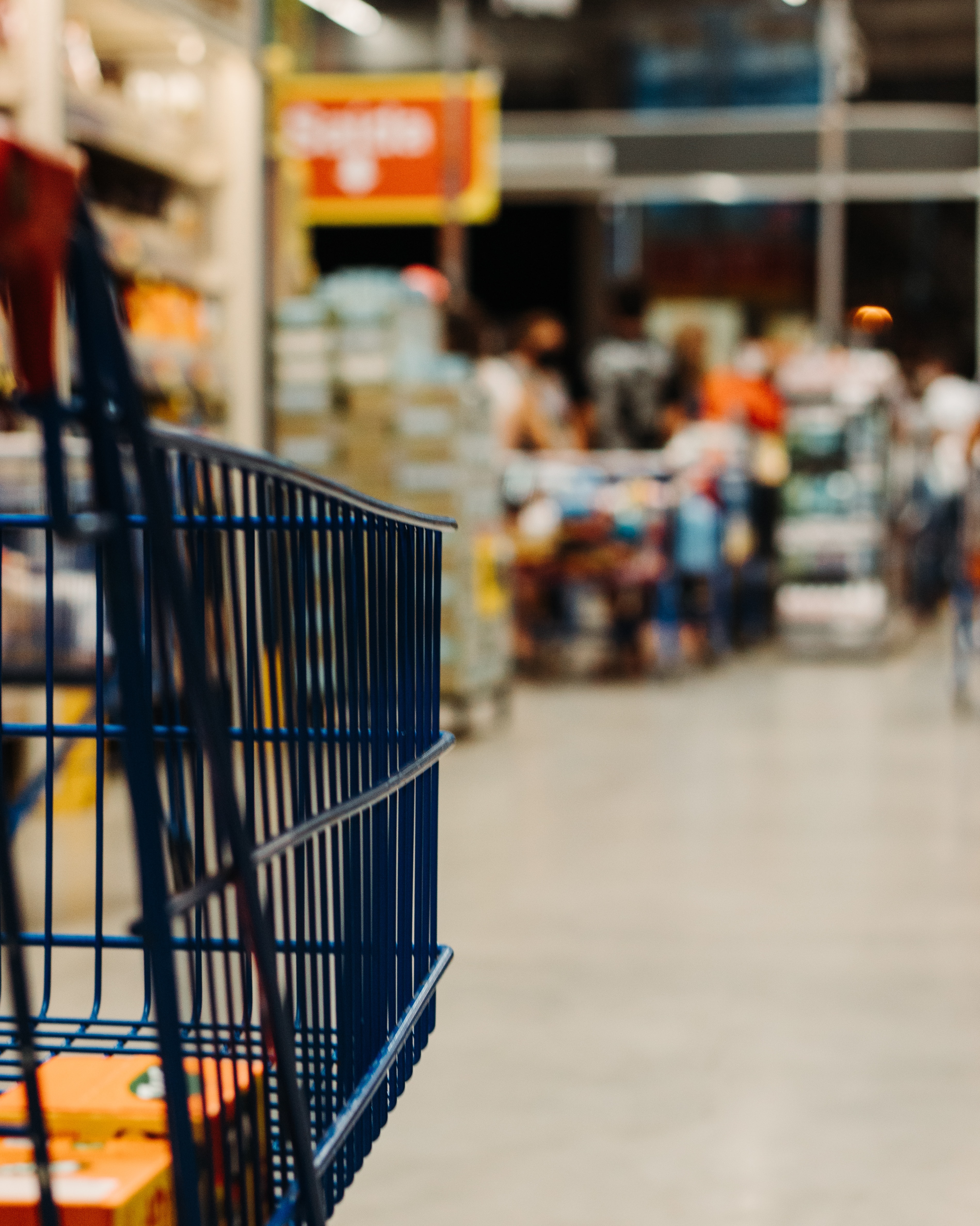 Shopping trolley beside supermarket aisles
