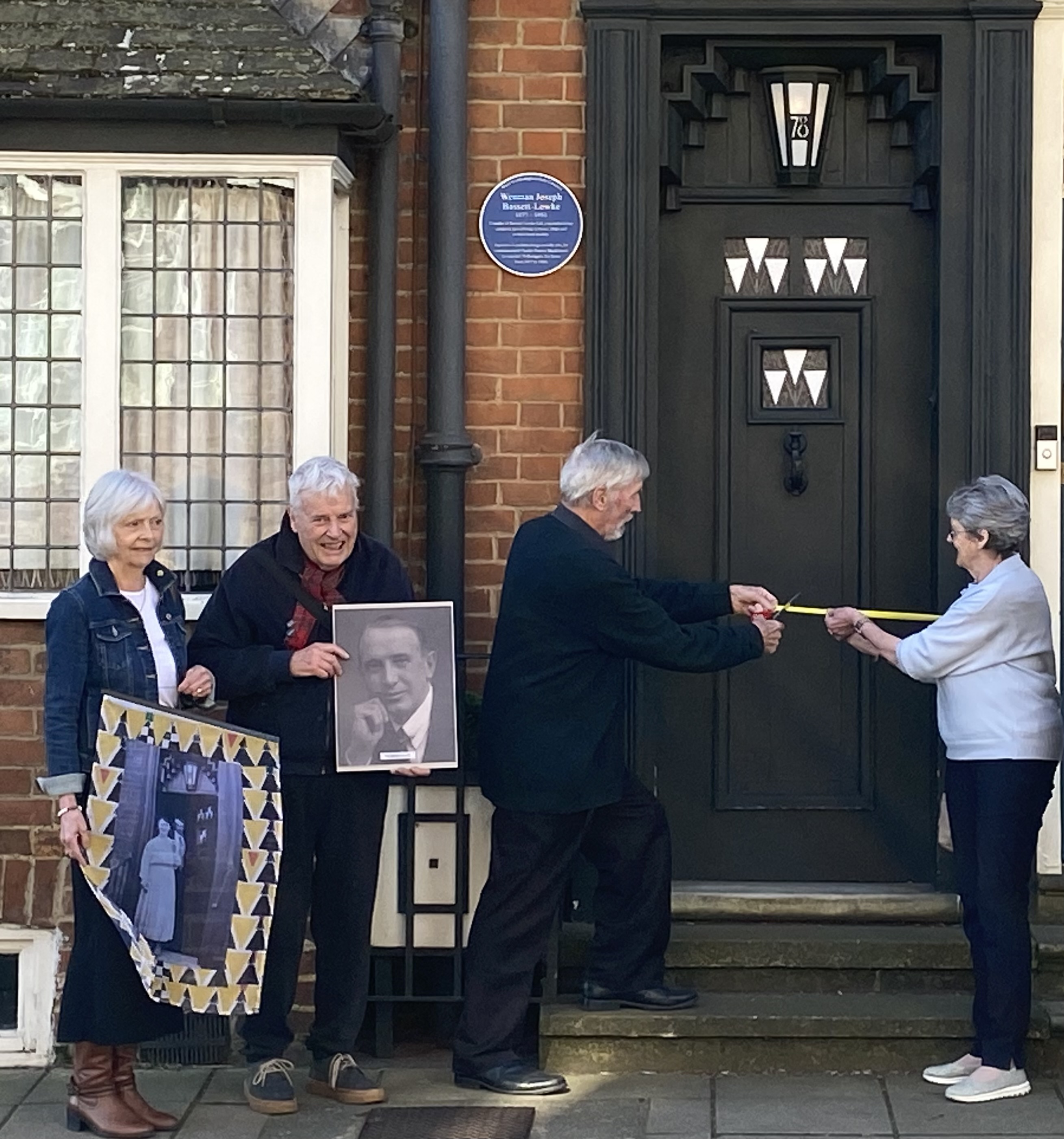 Rob Kendall cuts the ribbon to officially mark the installation of the Blue Plaque