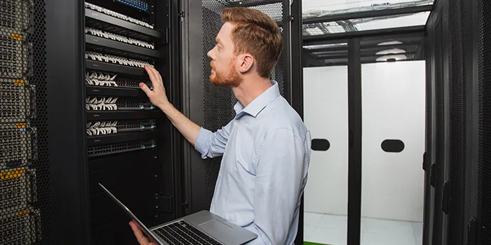 IT technician fixing network inside server room