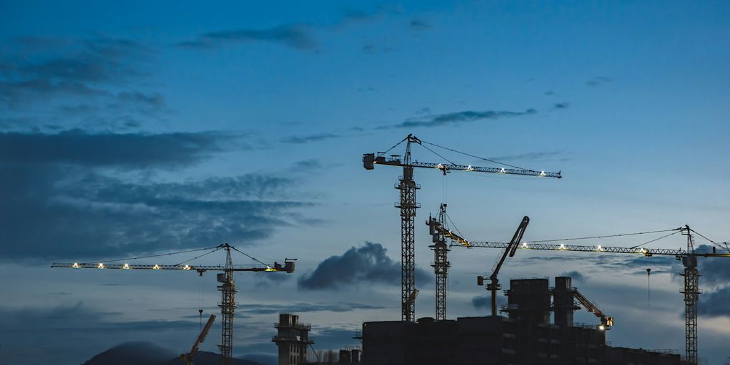 several cranes above the buildings