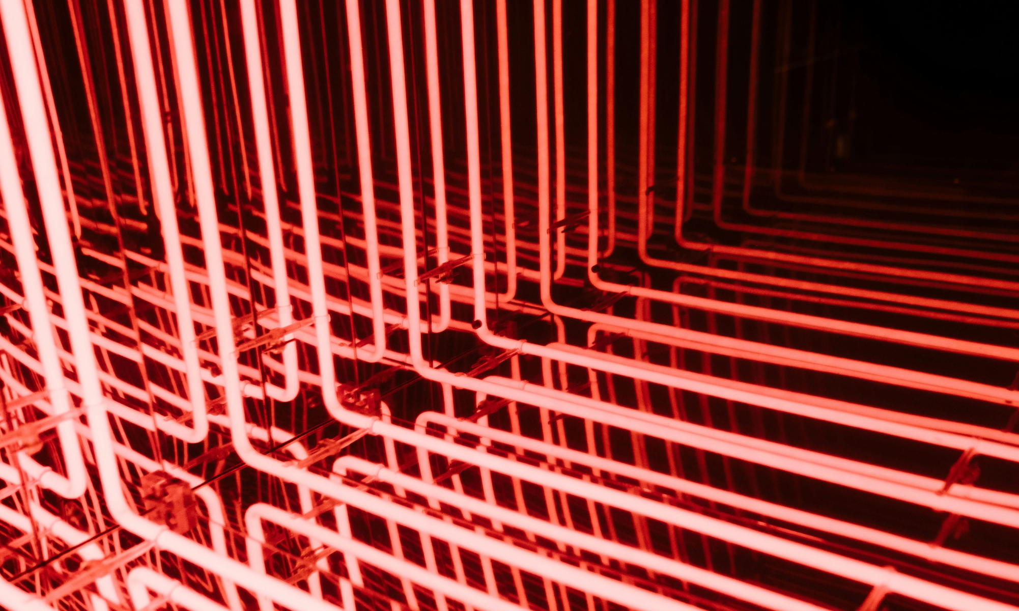 Abstract illustration of AI-driven product interfaces showing connected systems of interaction across chat, workflows and adaptive outputs instead of traditional screen-based journeys.