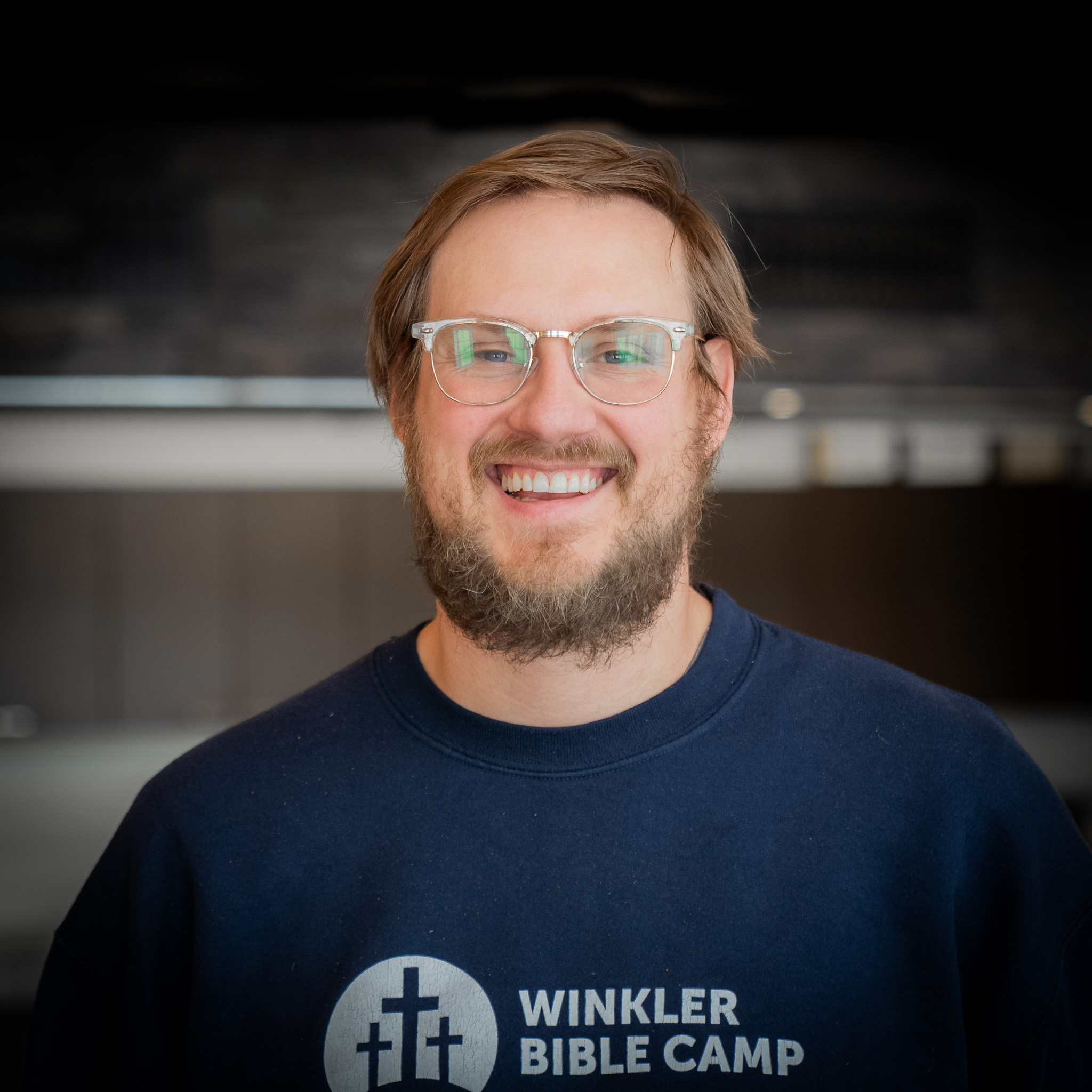 man with glasses and grey shirt